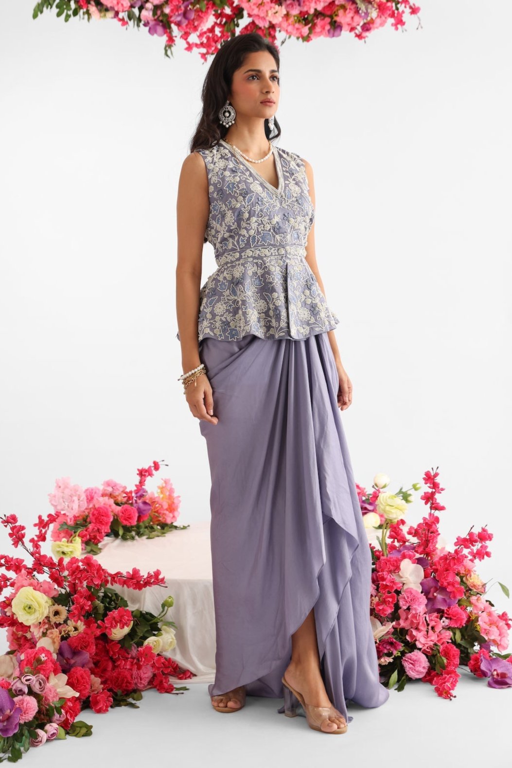 Icy blue peplum top with pearl and moti embroidery, 3D organza floral detailing, paired with matching draped skirt – Golden Muslin