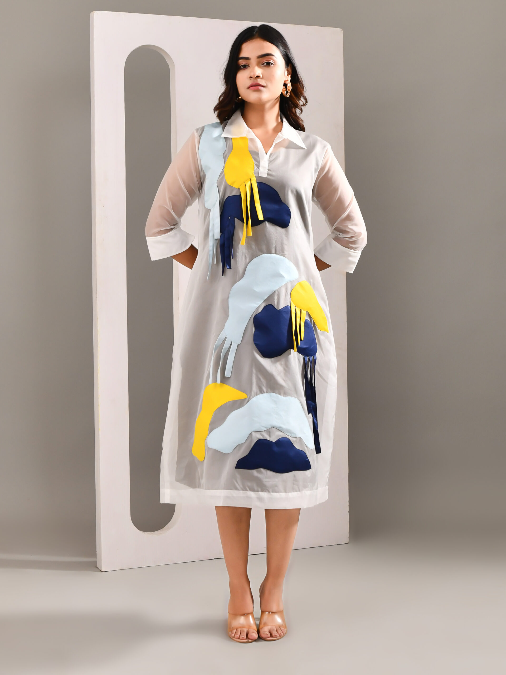 “Golden Muslin sheer organza multicolour patched overlay dress worn over a neutral sleeveless base dress.”