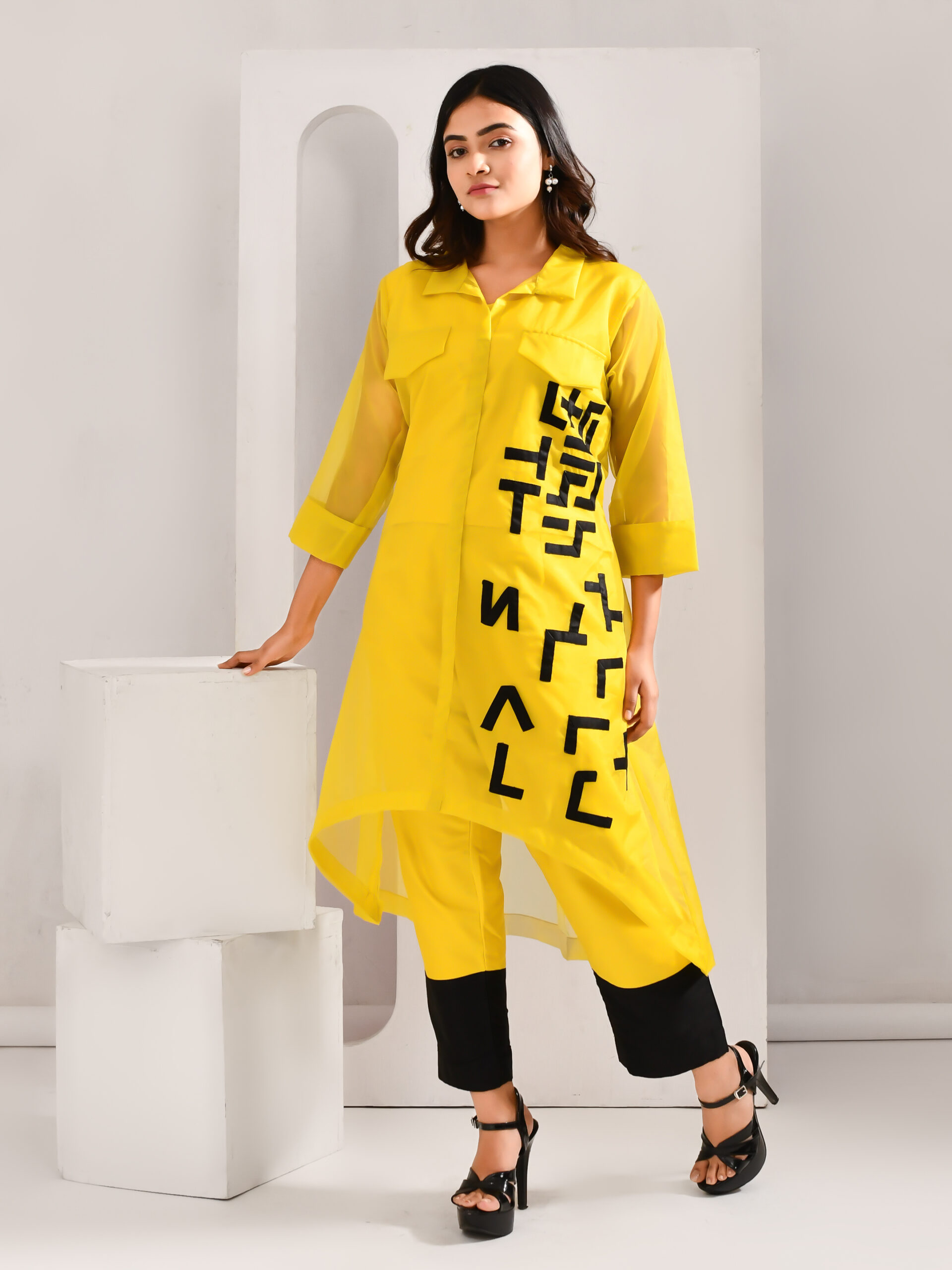 Yellow and black blended cotton co-ord set with sheer organza outer, patchwork detailing, pocket-style yoke, asymmetric hemline, and color-blocked pants – Golden Muslin