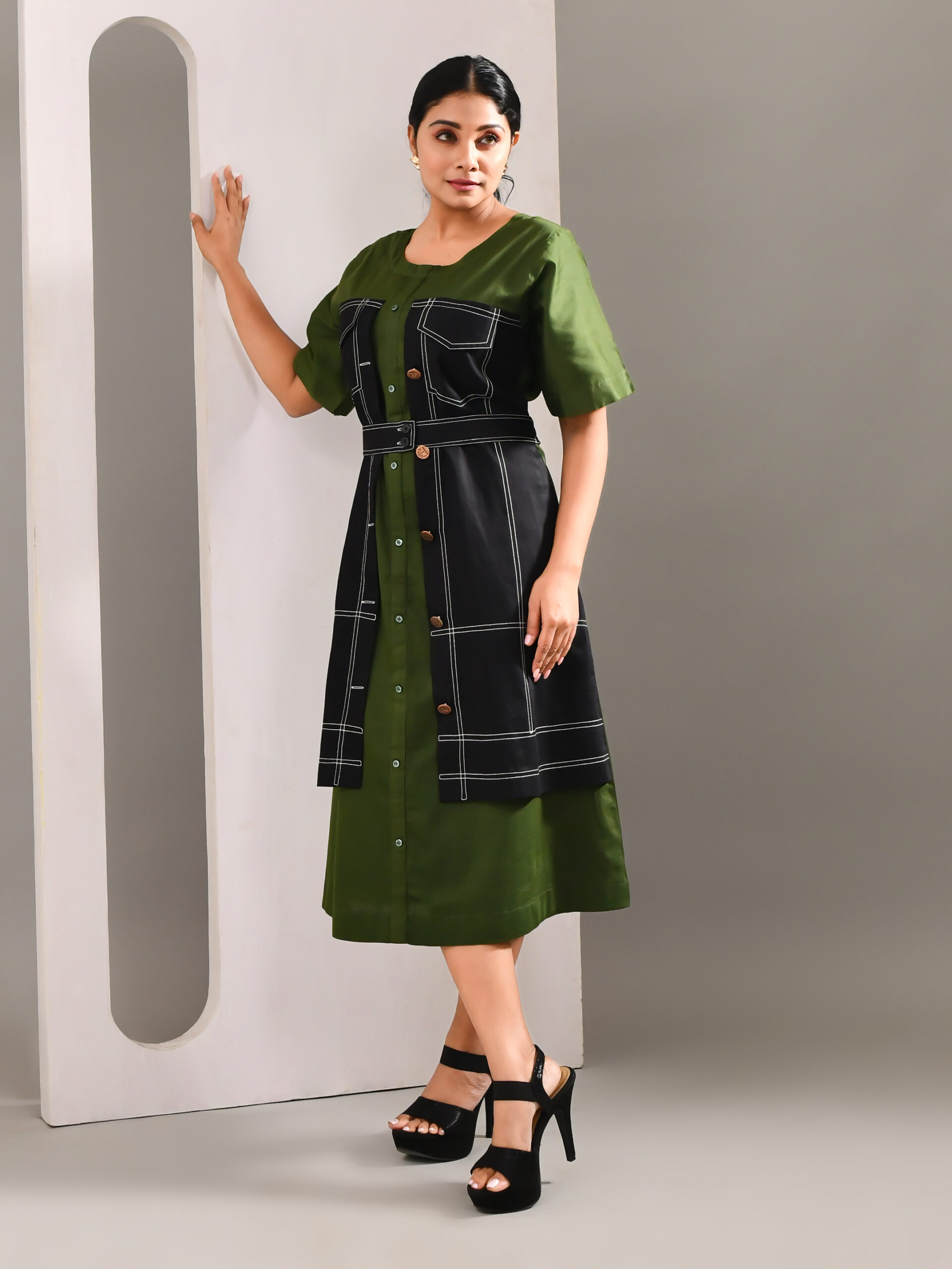 “Golden Muslin olive green blended cotton dress with denim-pattern detailing and front buttons.”
