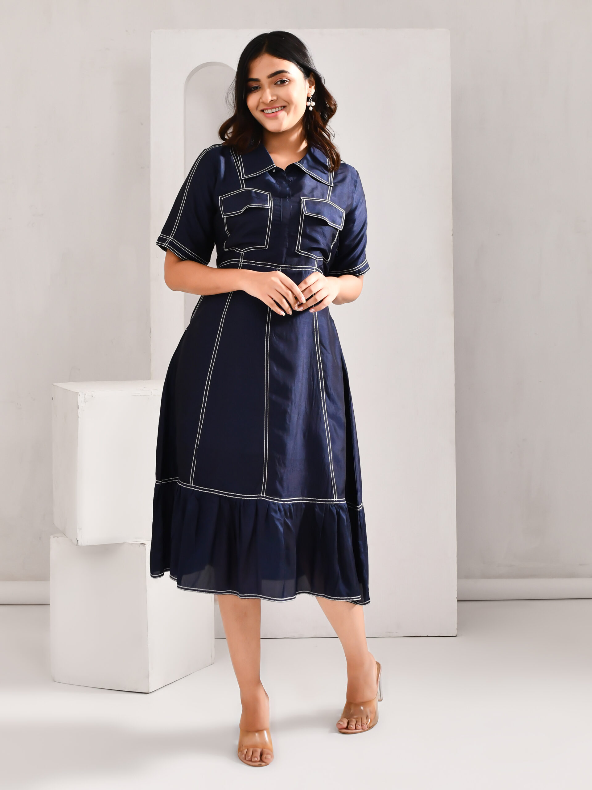 “Golden Muslin deep midnight blue blended cotton dress with silk-like sheen and anchoring threads highlighting a panelled structure.”