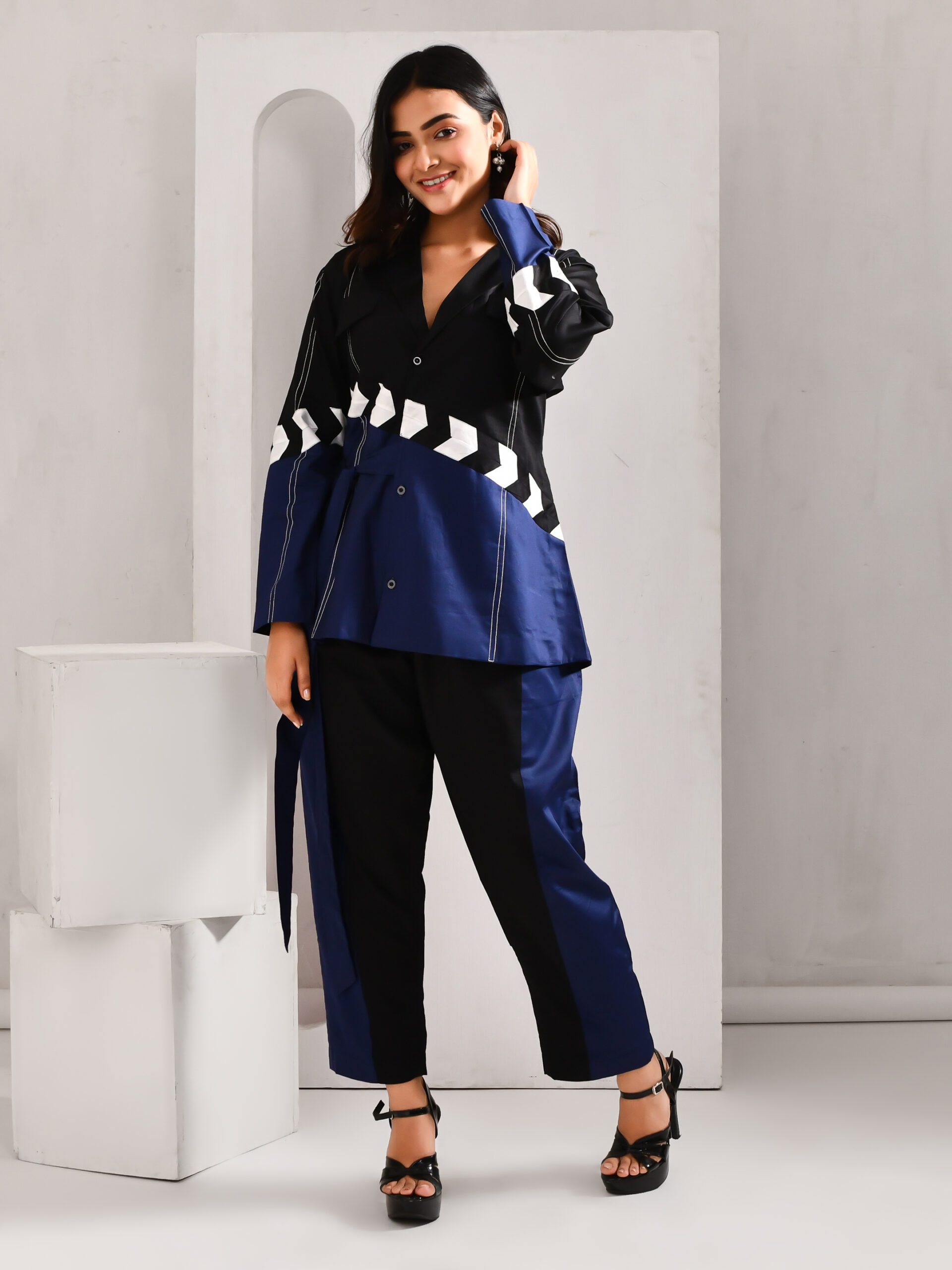 “Golden Muslin deep blue and black blended cotton jacket-style co-ord set with waist tie belt and straight-leg pants.”
