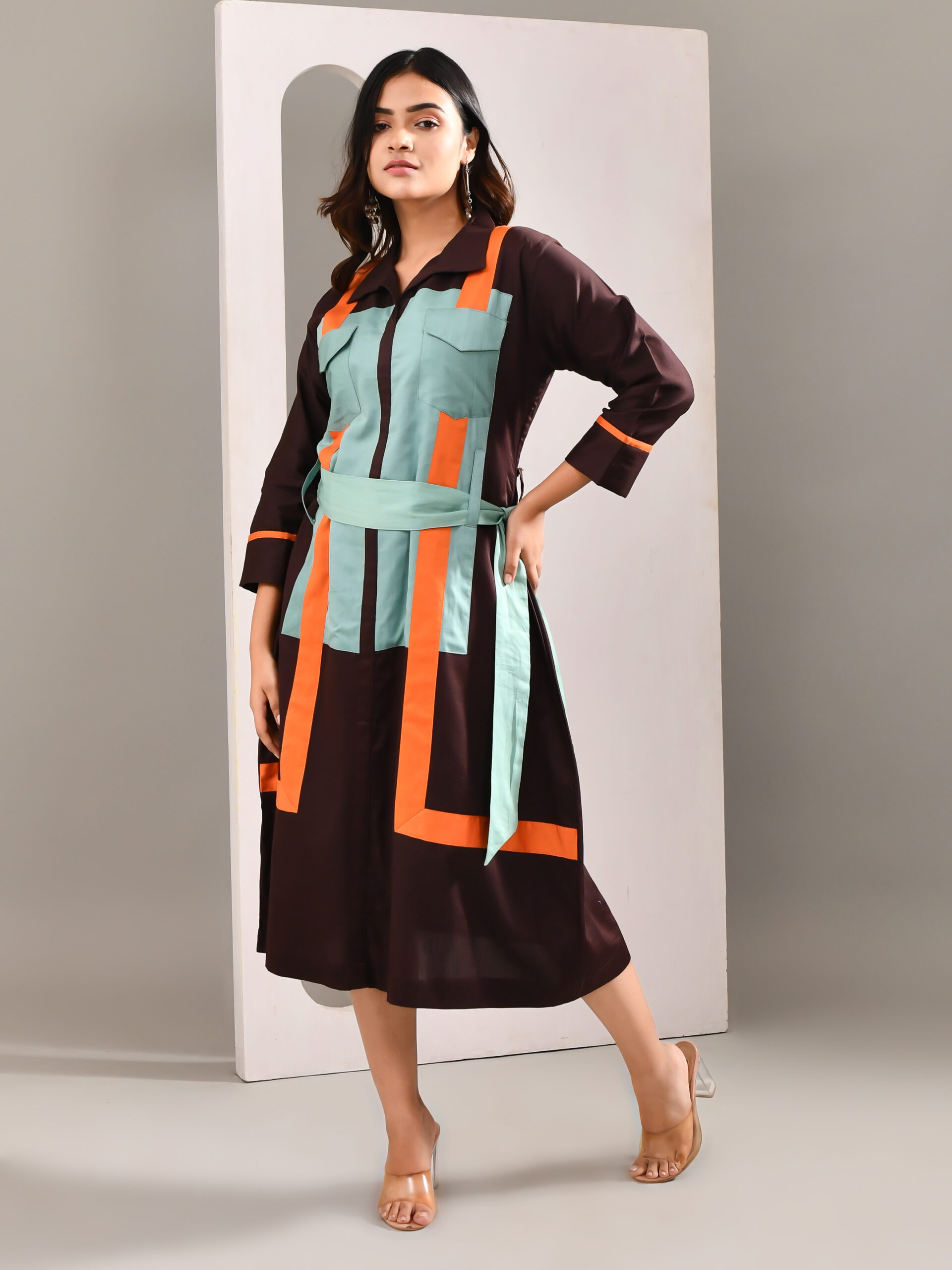 “Golden Muslin dark purplish brown blended cotton A-line dress with belt tie and subtle contrast color detailing.”