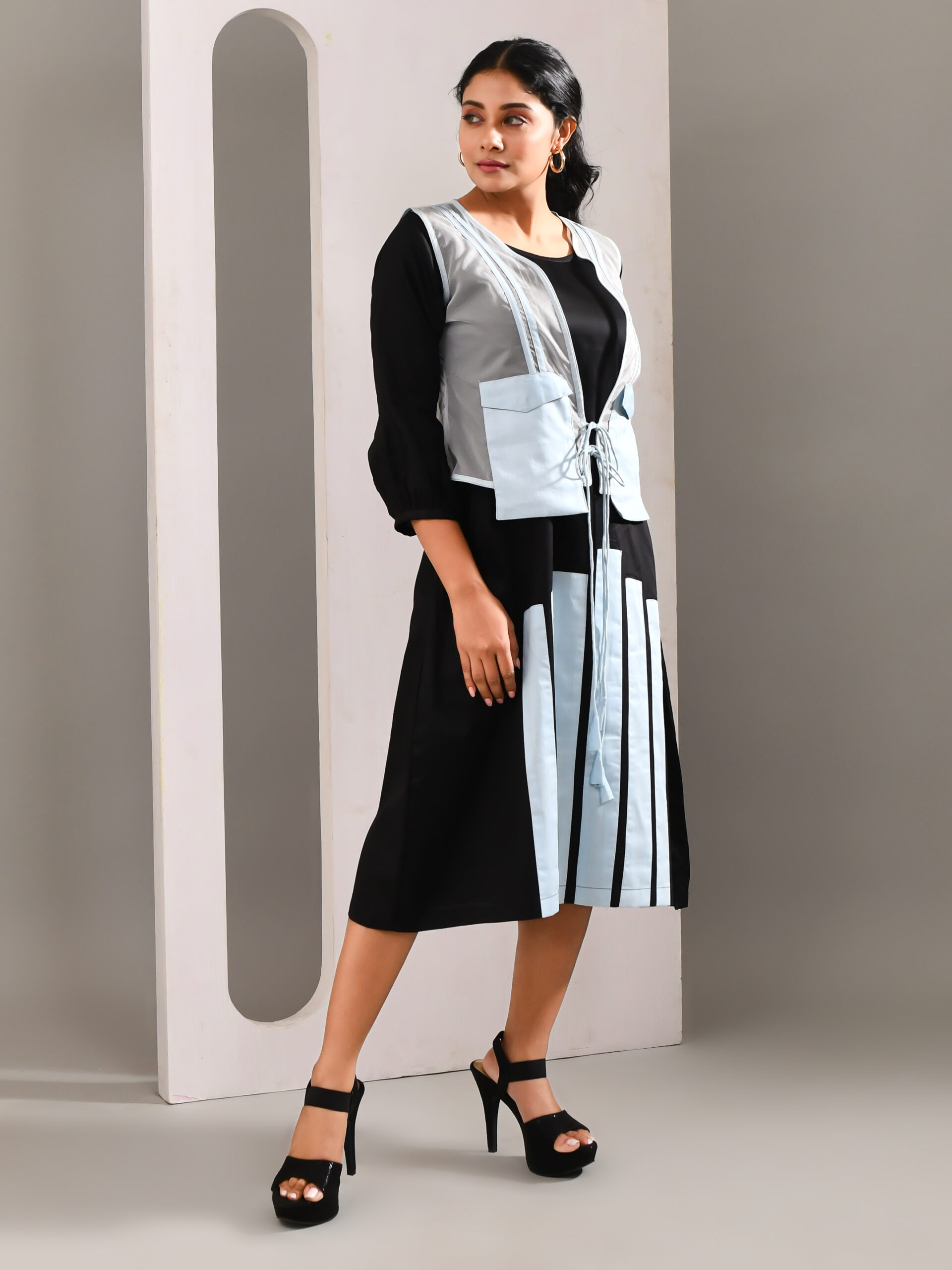 “Golden Muslin black and light blue blended cotton midi jacket dress with subtle patchwork, front waist tie, and sheer color-accented jacket.”