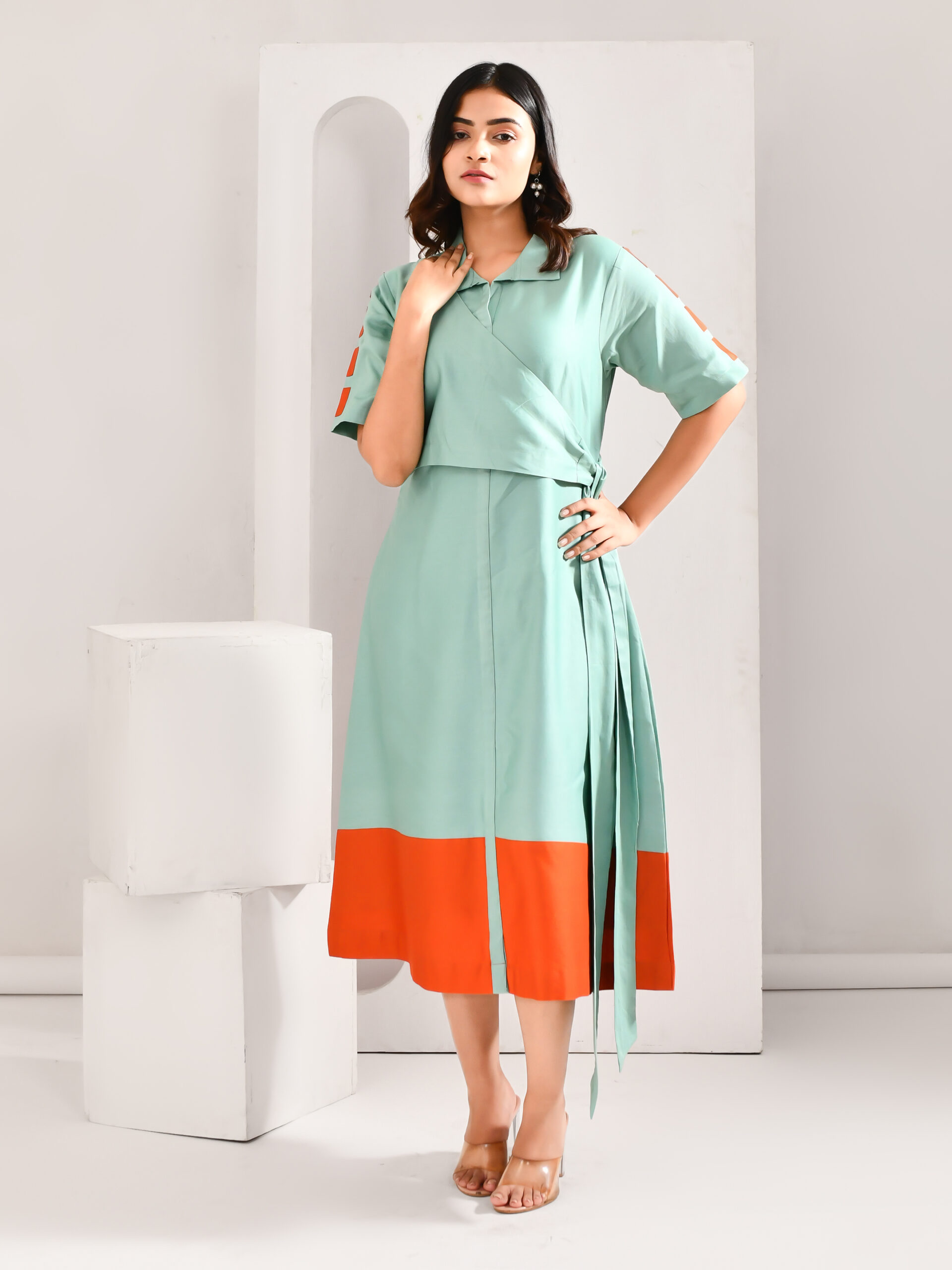 “Golden Muslin light blue and orange blended cotton dress with jacket-style yoke and vibrant color-pop hem.”