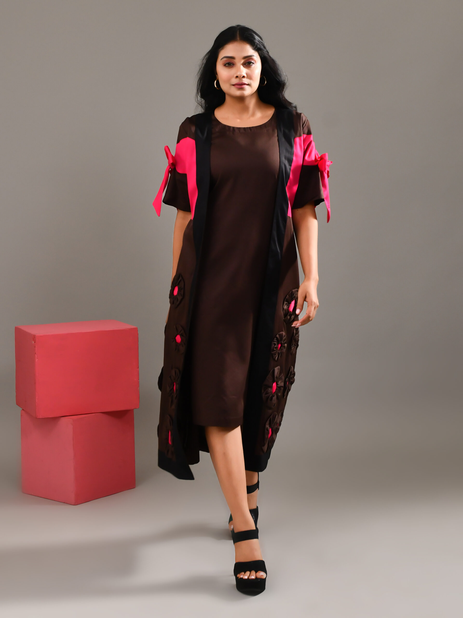 “Golden Muslin chocolate brown blended cotton dress with paneled jacket overlay, bow detail, and intricate patchwork.”