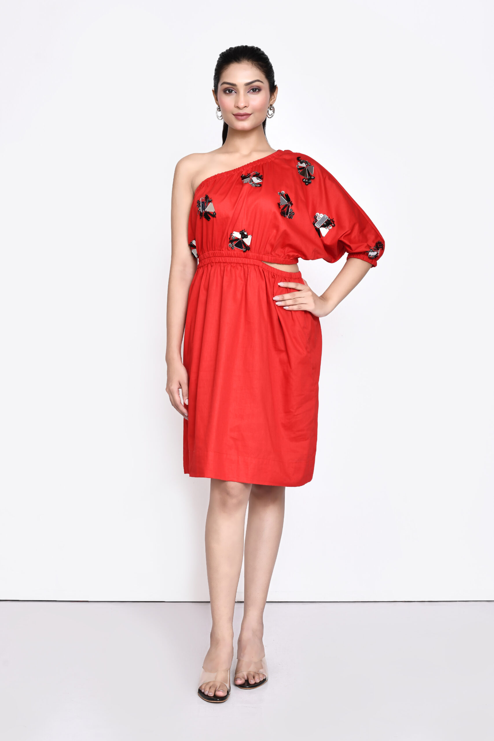 Golden Muslin Jaanvi Mohta red cotton satin one-shoulder dress with chunky embellishments and cut-out elasticated waist