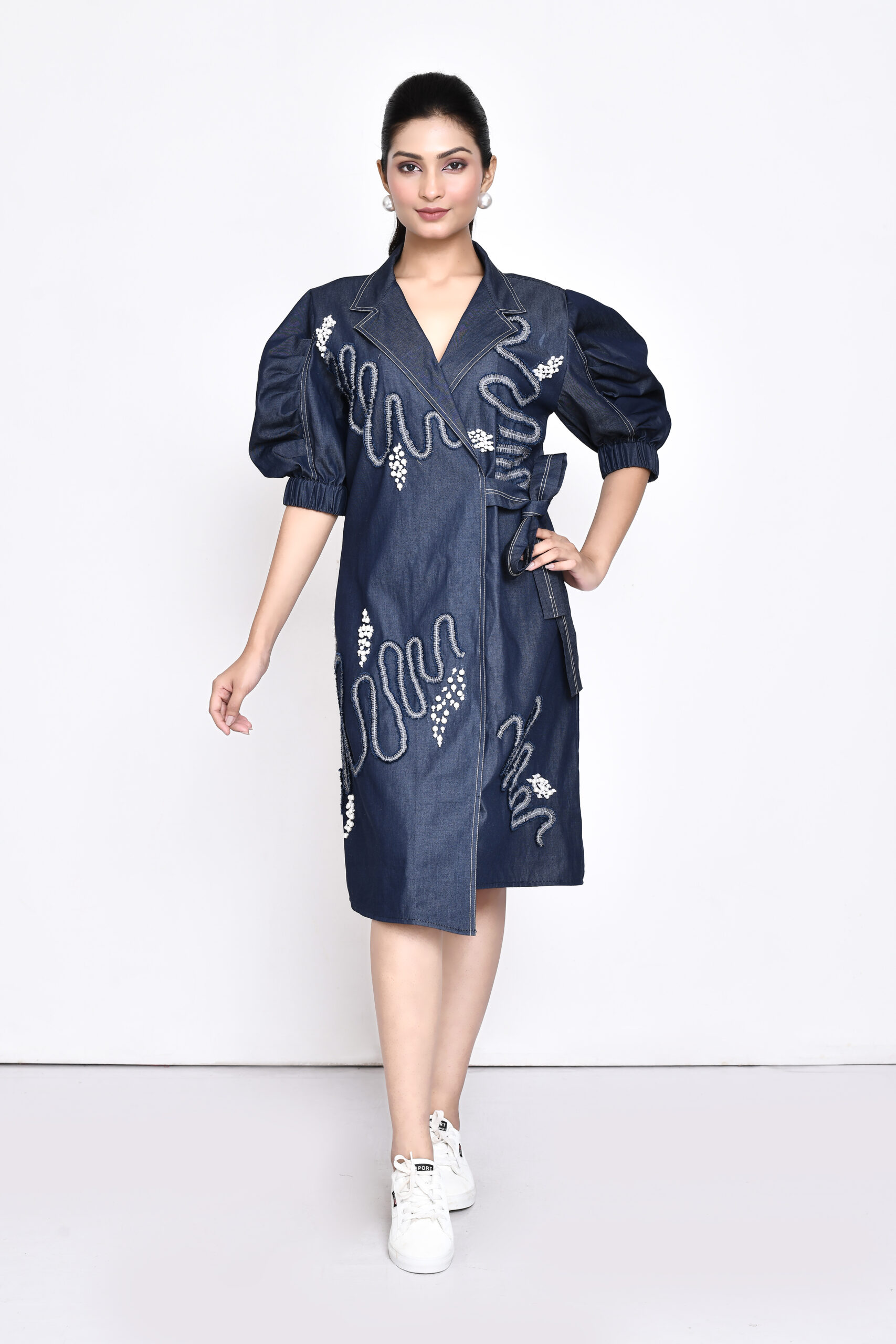 Golden Muslin overlap denim dress with tie-up belt, stylized sleeves, lapel collar, and pearl and denim embellishments