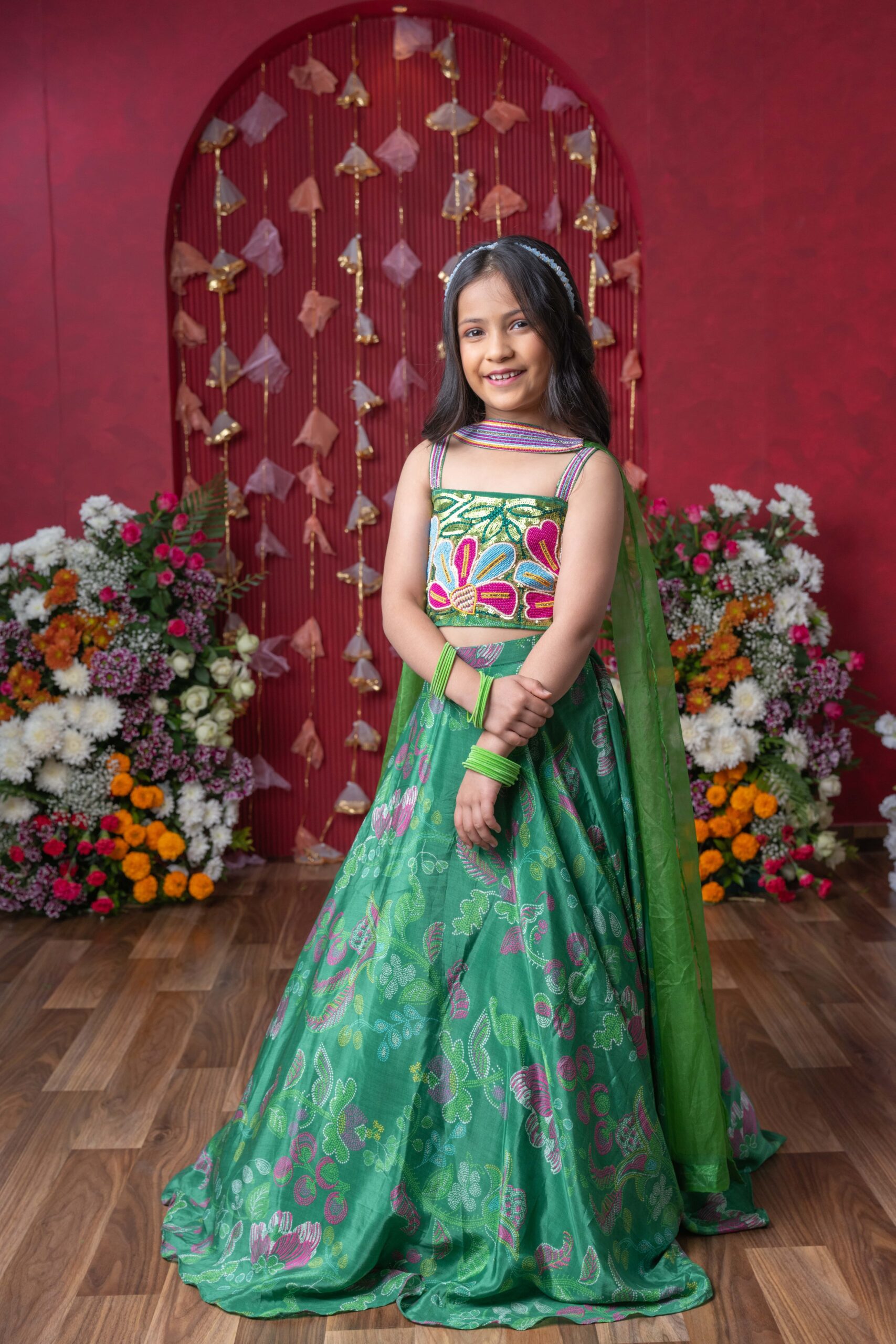 Green crepe girls’ lehenga choli set with multicolored floral embroidery, printed lehenga, and organza dupatta – Golden Muslin