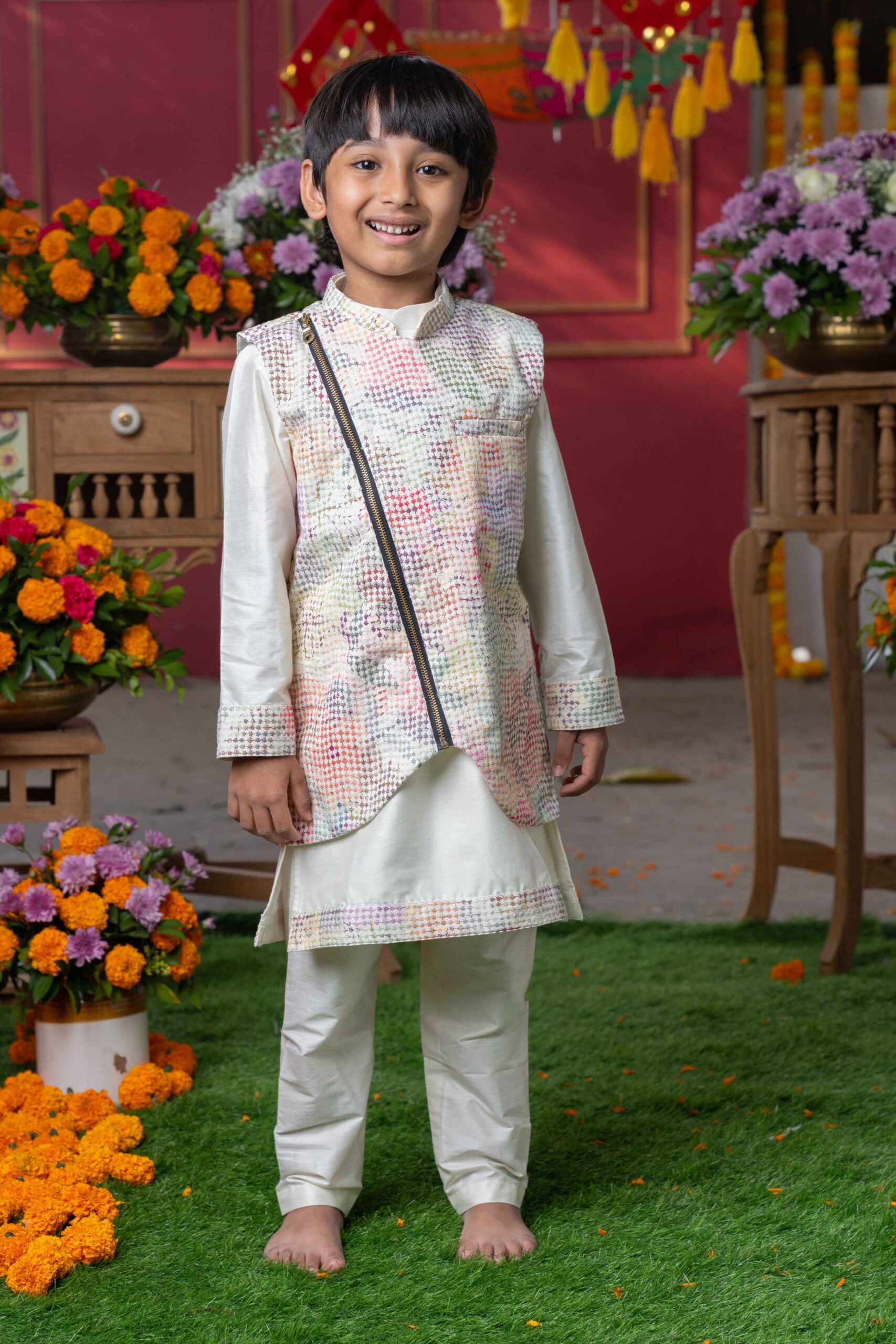 Cream silk kurta with embroidered cuffs, pastel checkered Nehru jacket with asymmetrical zipper, and cream straight-cut pants – Golden Muslin