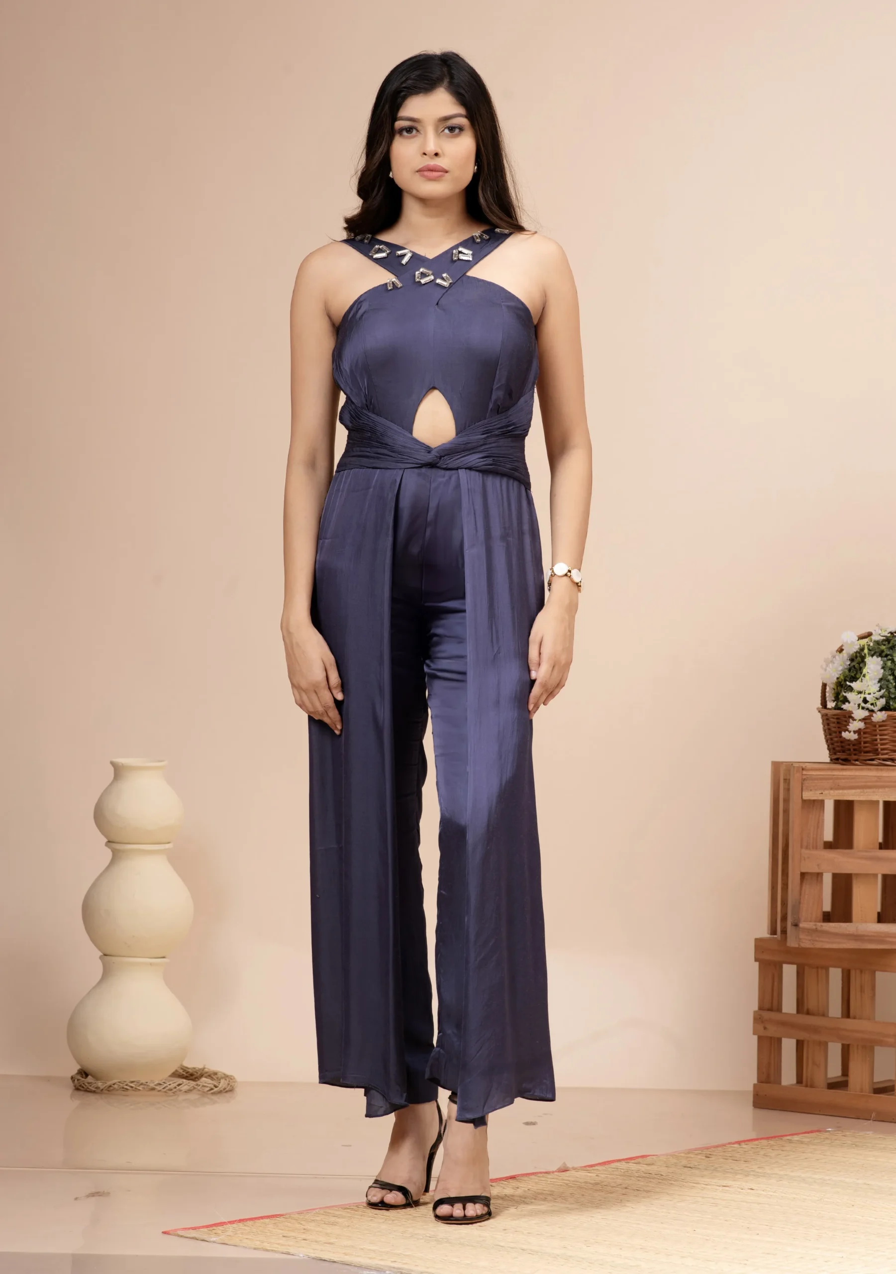 Navy blue satin halter jumpsuit with a keyhole cutout and twisted waist By Kumar Rahul from the house of Golden Muslin.