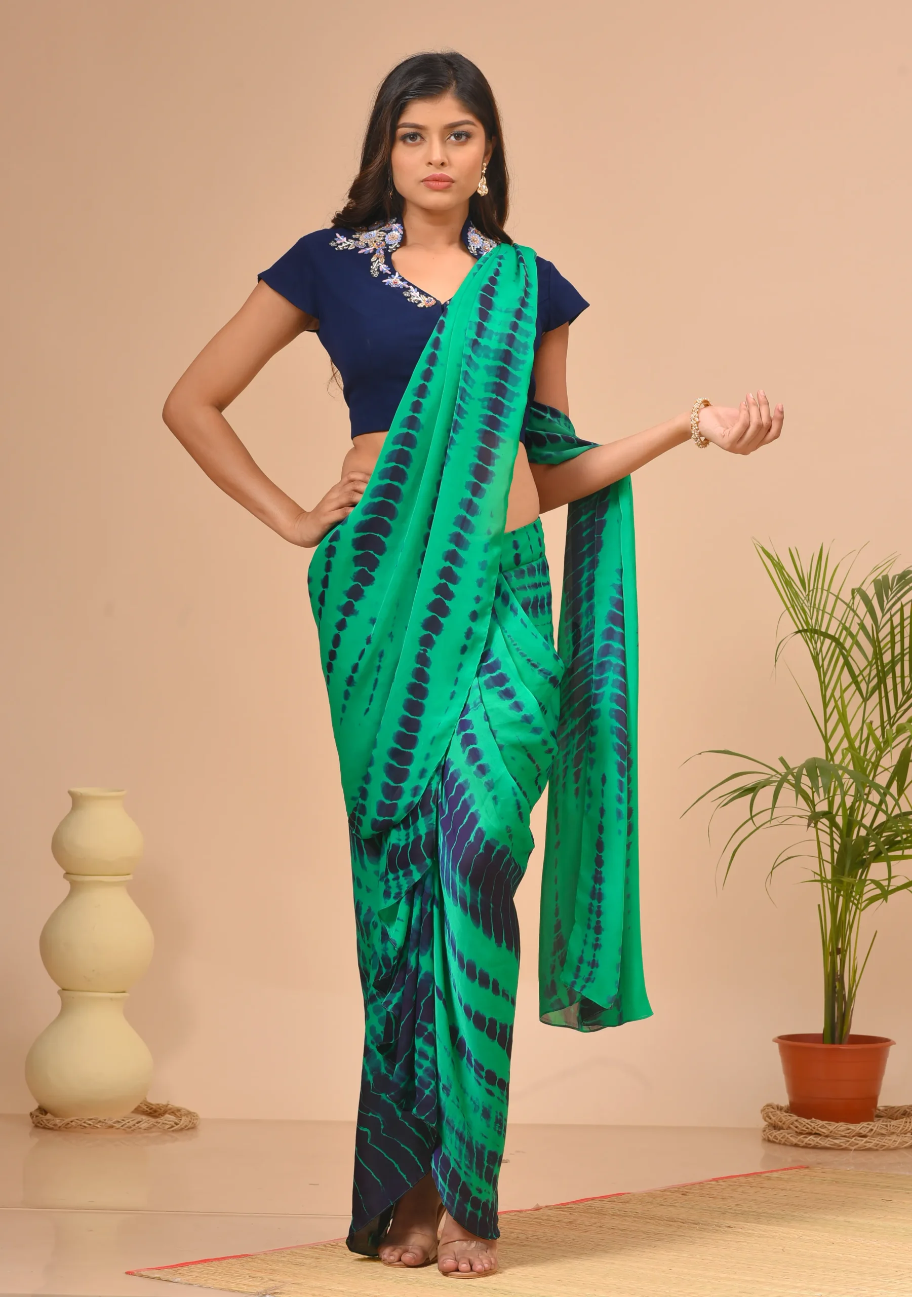 Bright teal green tie-dye silk saree by Kumar Rahul from the house of Golden Muslin with a floral embroidered blouse.