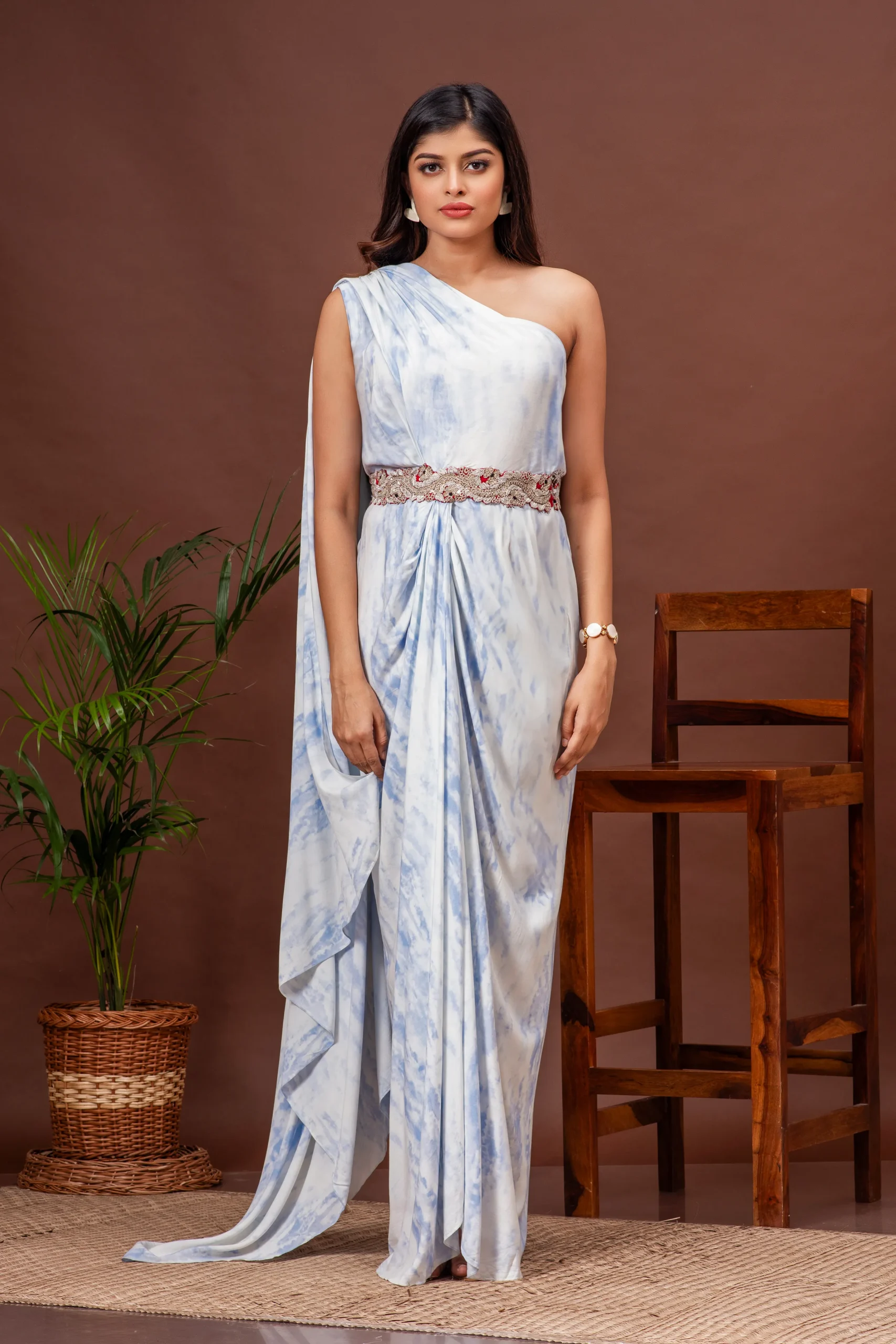 Sky blue tie-dye one shoulder draped gown with waist embroidery by Kumar Rahul from the house of Golden Muslin.