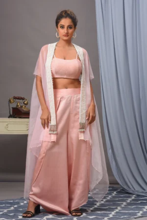 Baby pink organza cape, quilted bustier, and palazzo from the house of Golden Muslin by Satya JB with tassel details.
