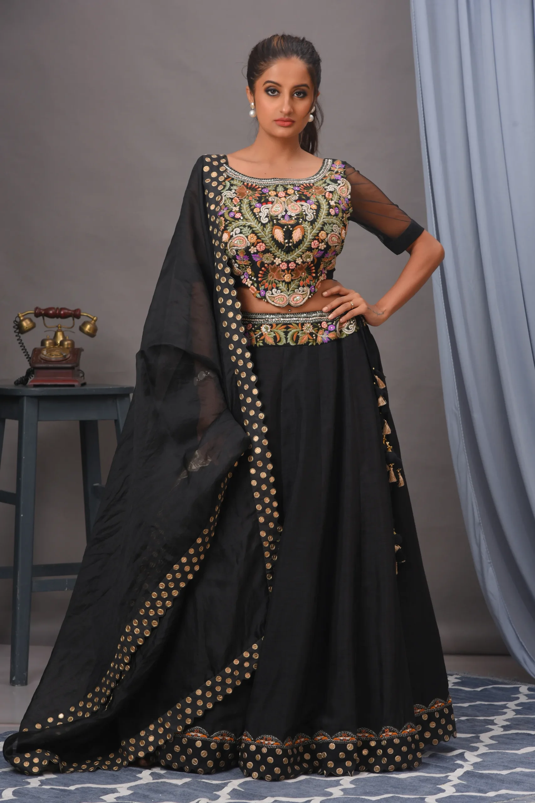 Black Bamberg silk lehenga with multicolored embroidery and organza dupatta by Satya JB from the house of Golden Muslin.