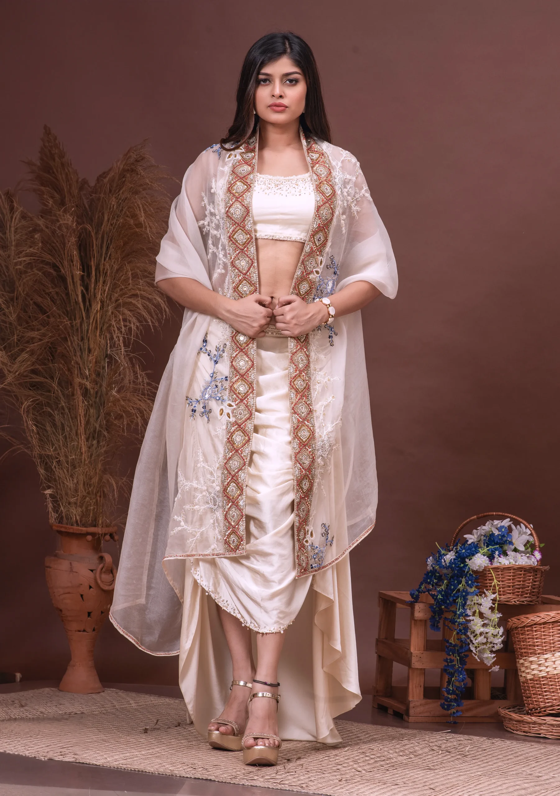 Beige embroidered bustier and cowl skirt by Satya JB from the house of Golden Muslin with organza dupatta.