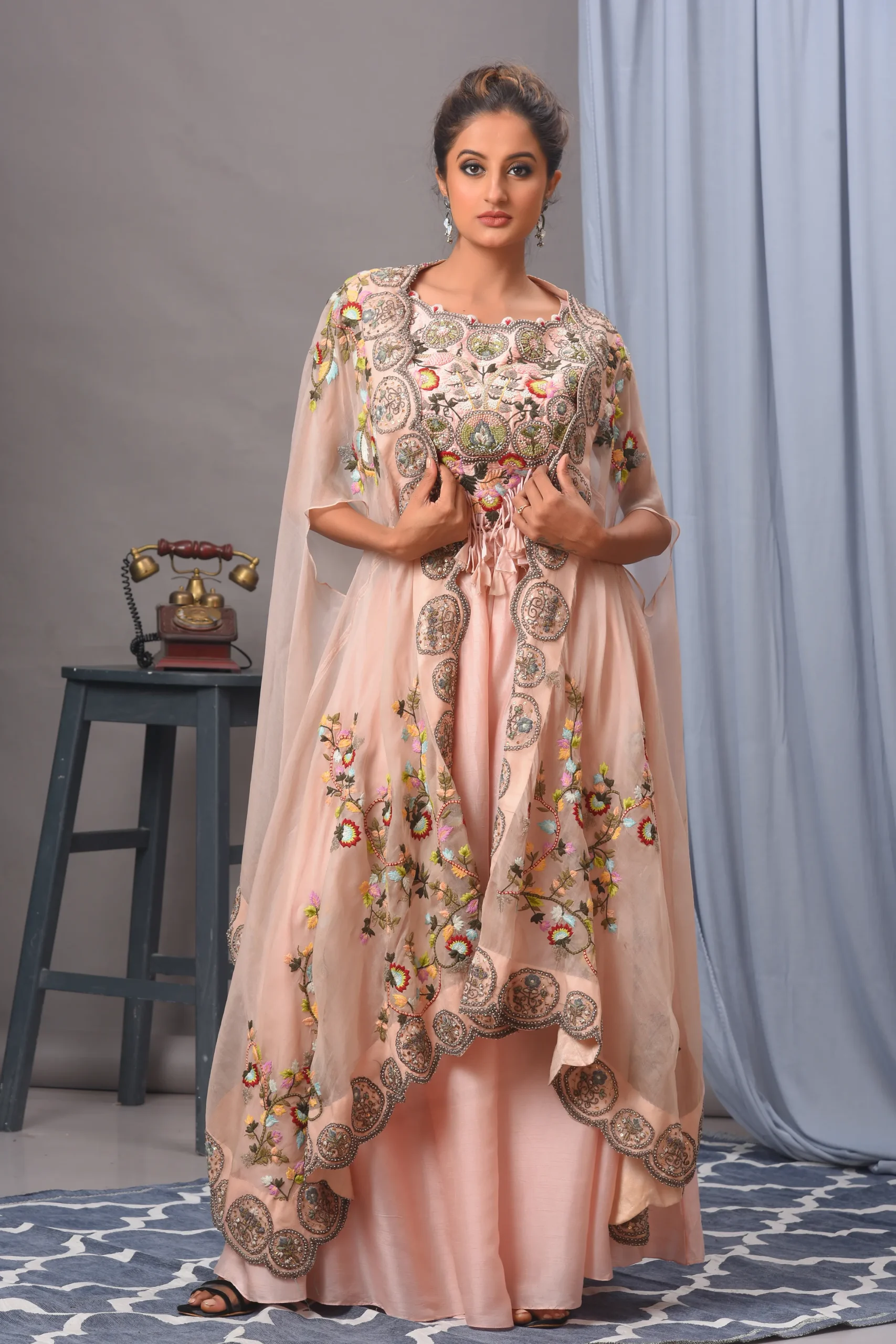 Baby pink silk cape and organza sharara from the house of Golden Muslin by Satya JB with floral scalloped edges.