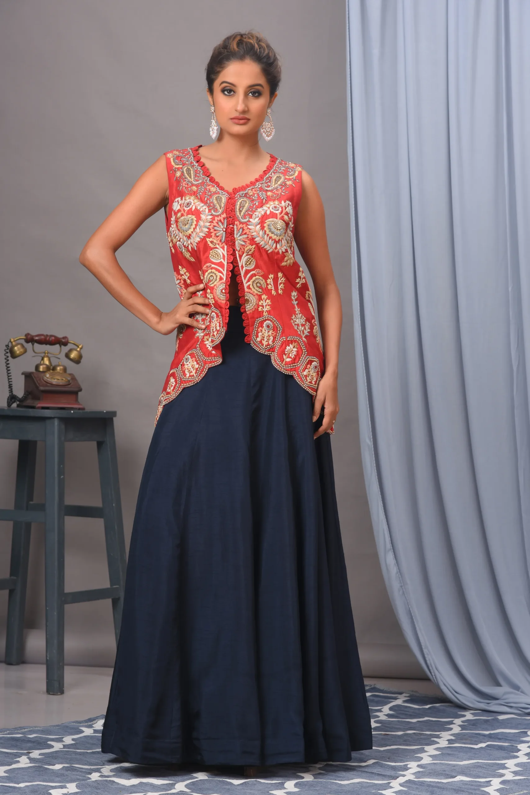 Intricately embroidered red Bamberg silk jacket and navy skirt by Satya JB from the house of Golden Muslin.