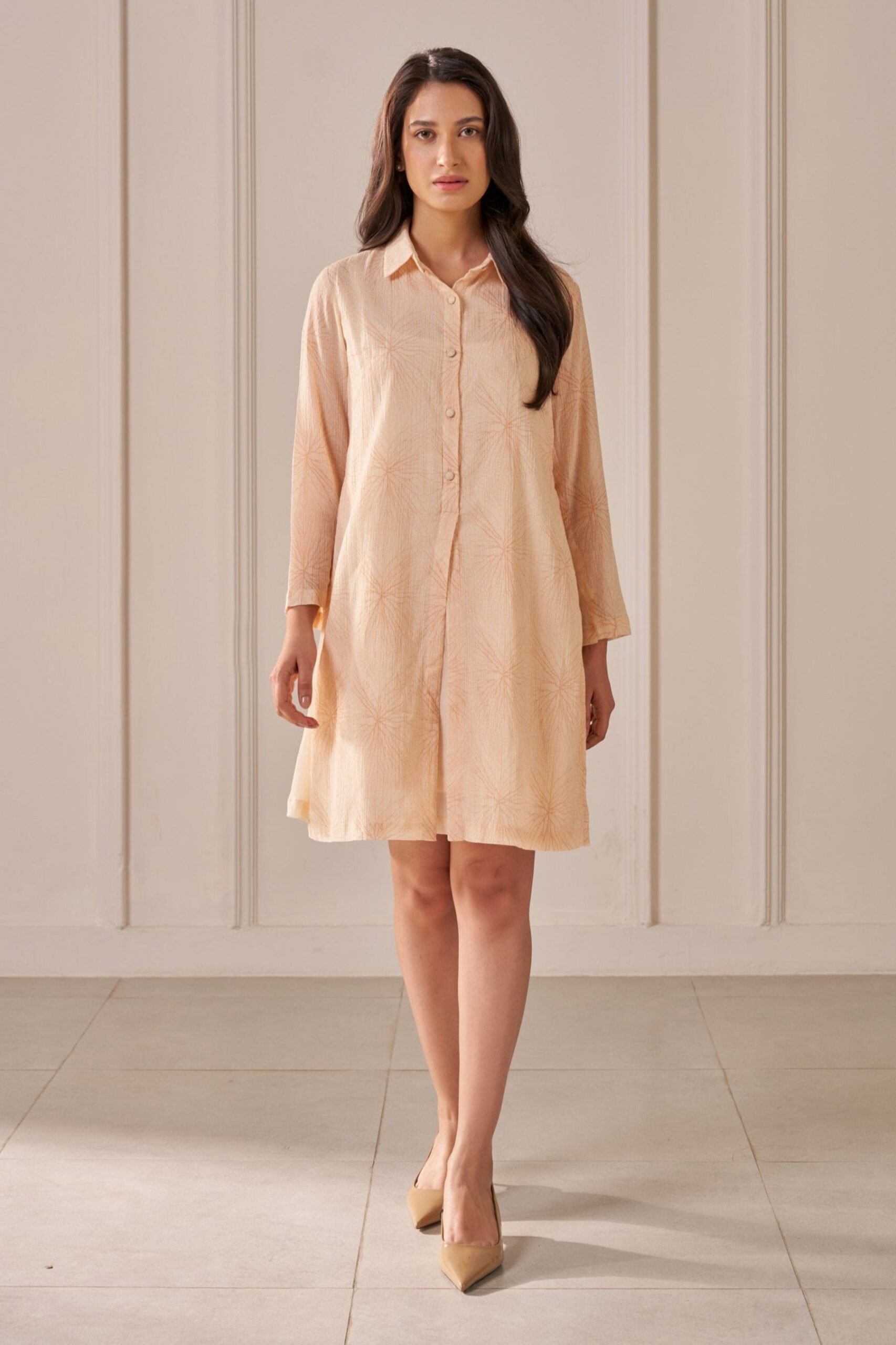“Golden Muslin soft peach printed crepe cotton straight-fit layered dress with shirt collar, button placket, and two-piece sleeves.”