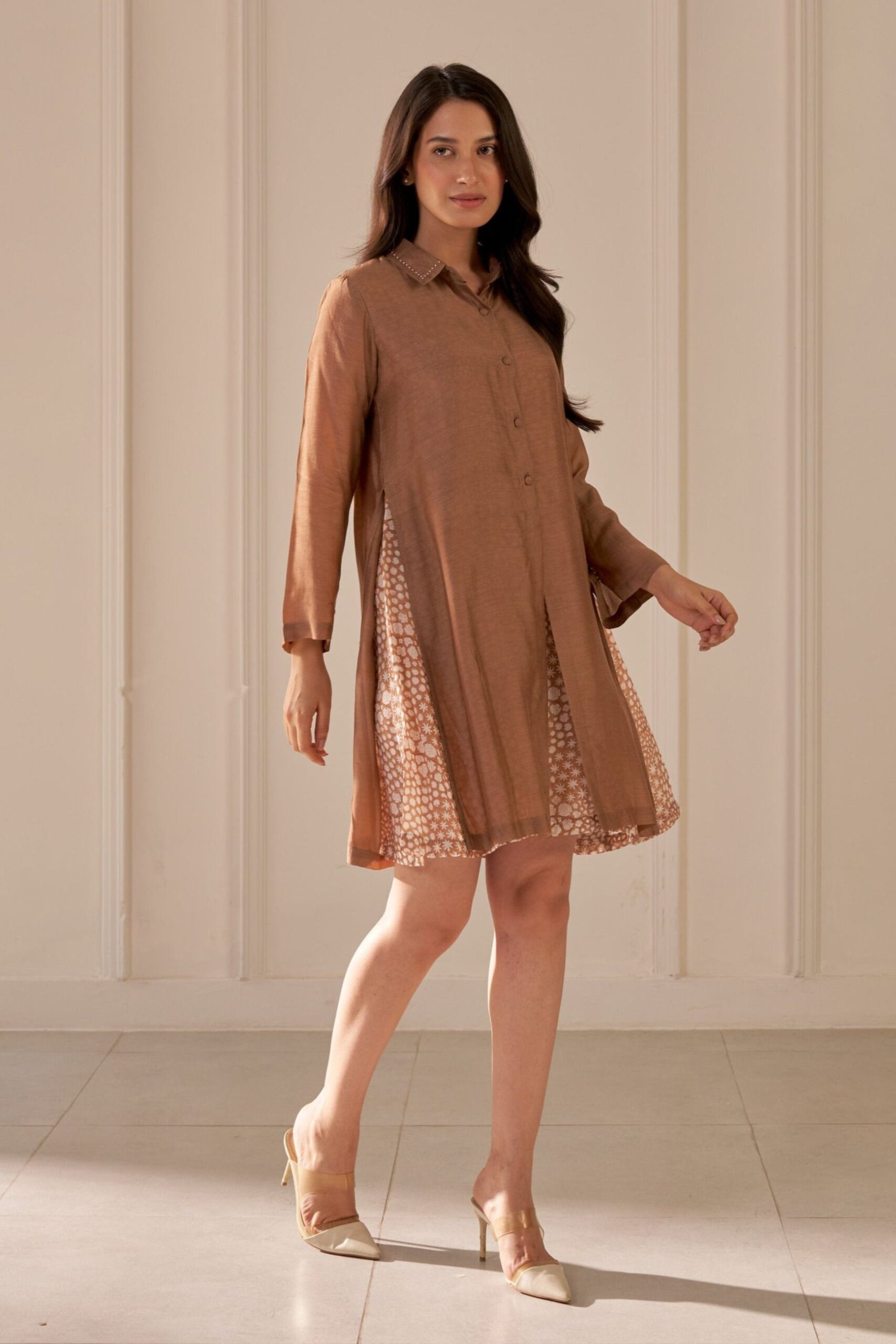 “Golden Muslin brown muslin silk straight-fit knee-length layered dress with shirt collar, two-piece sleeves, beadwork detailing, and inner block-printed layer.”