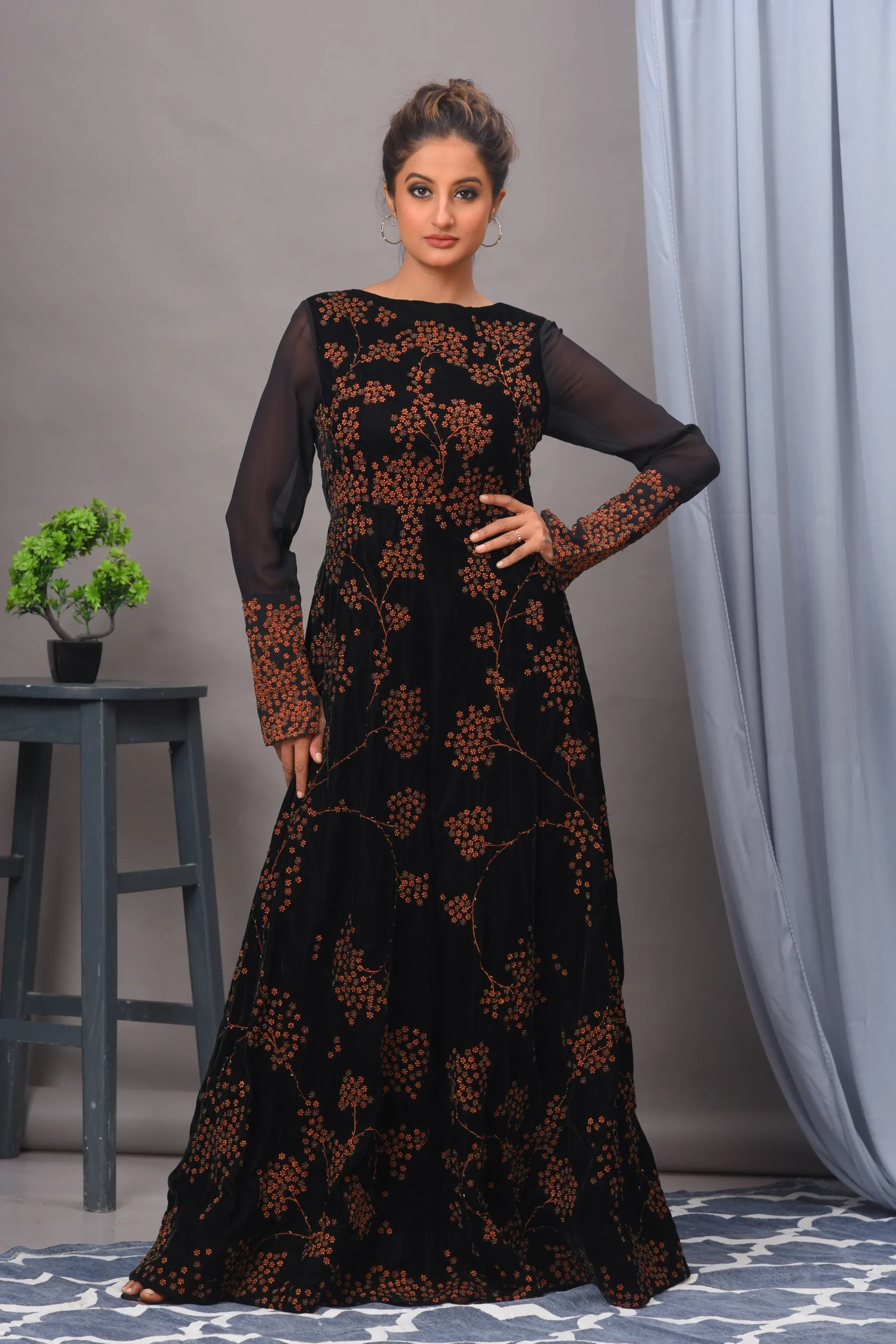 A stunning black velvet gown from Golden Muslin By Vivek Kumar, featuring intricate light-reflecting embroidery and a modern flattering silhouette.