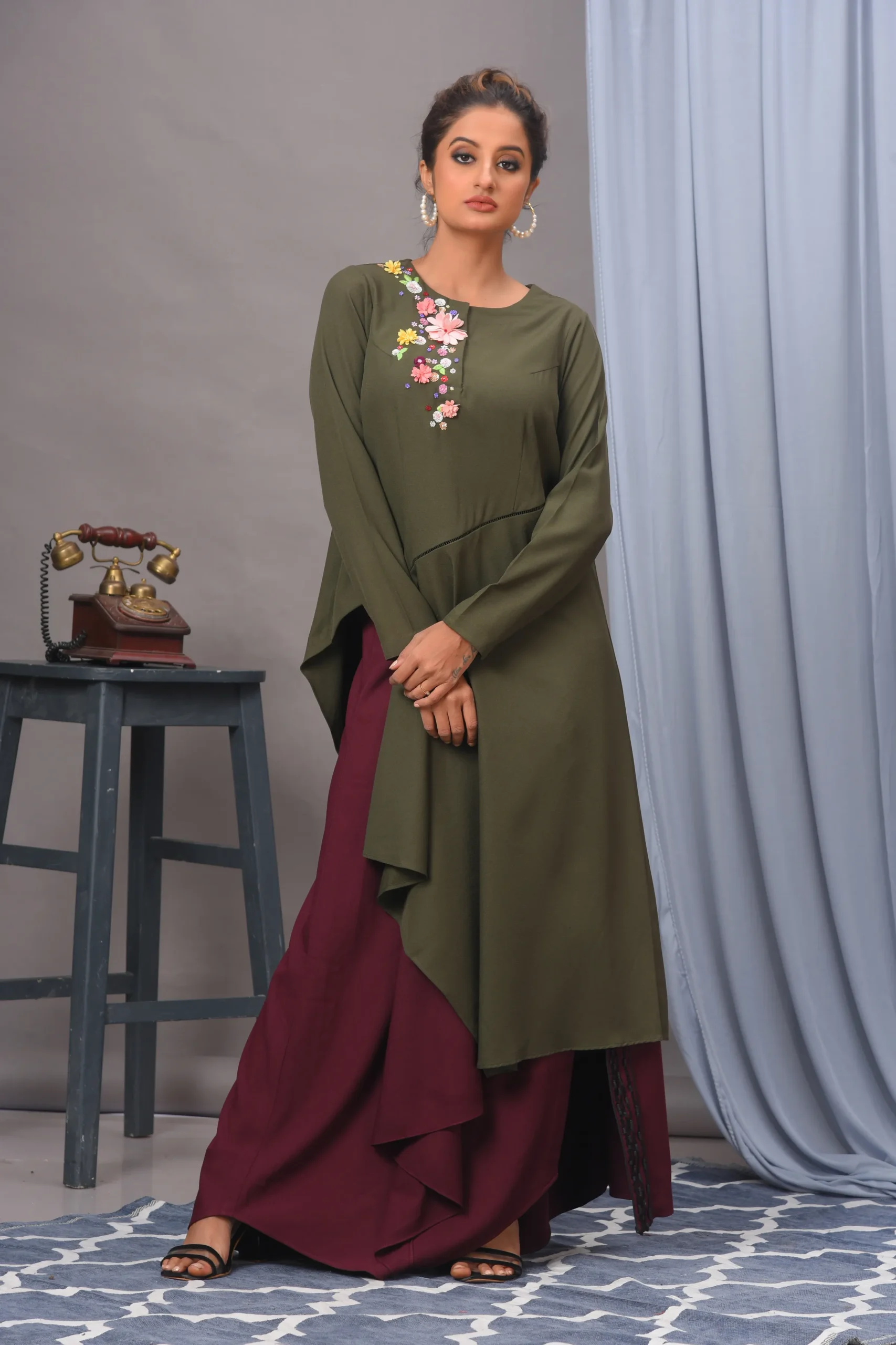 Olive green crepe top with 3D floral neckline and wine draped slit skirt by Vivek Kumar from Golden Muslin.