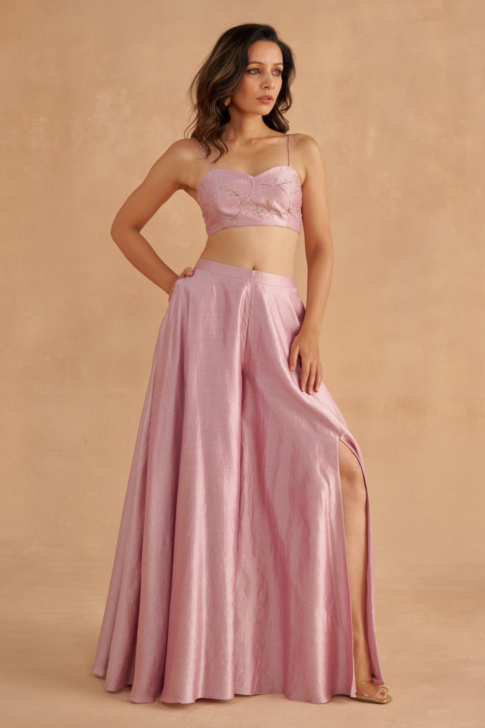 “Golden Muslin soft lilac sweetheart-neck blouse paired with fine silk lilac Sharara pants featuring waist belt, pockets, and modern slit.”