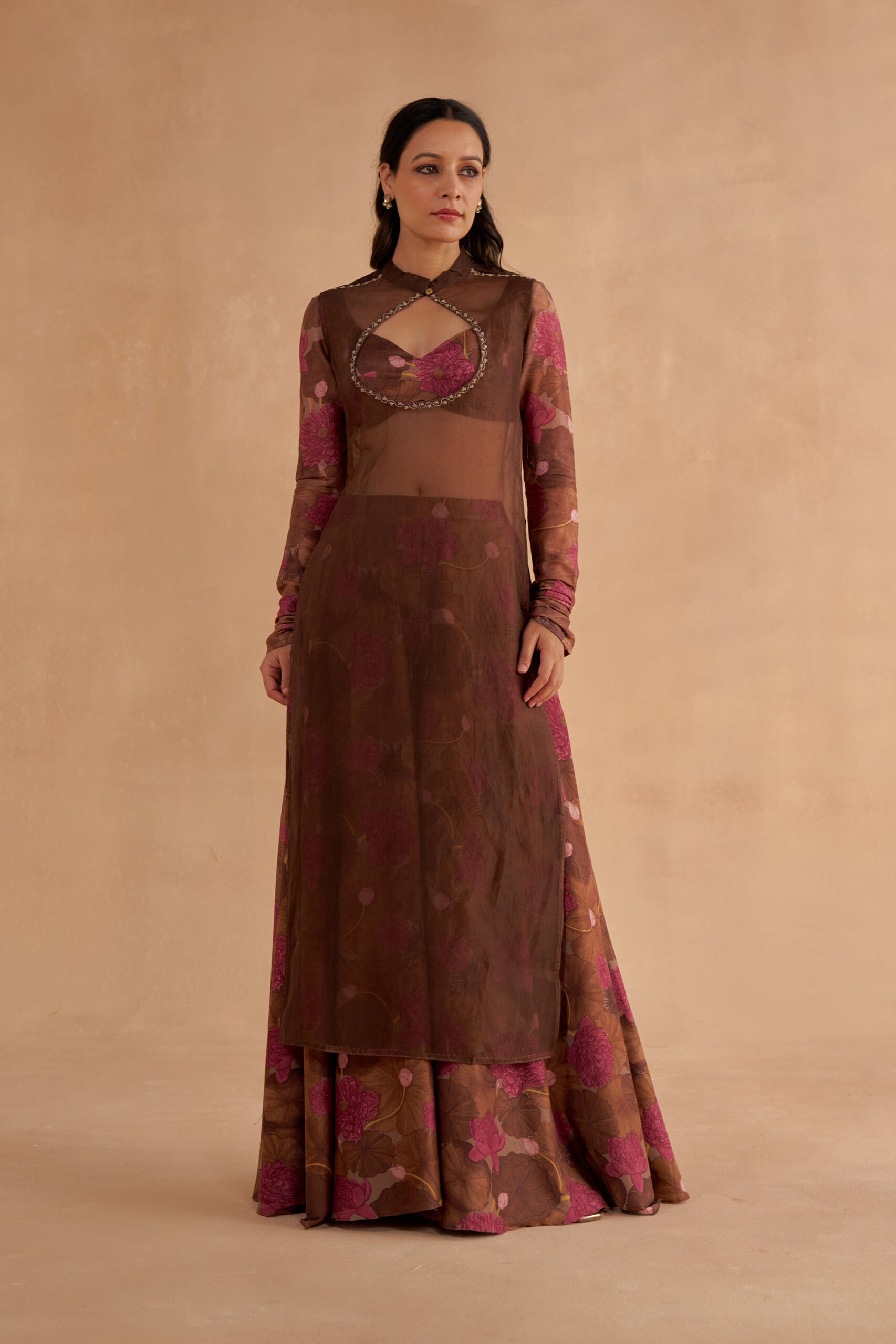 Golden Muslin walnut-brown bustier blouse with signature lotus print sleeves, sheer sleeveless kurta with keyhole neckline, and lotus-printed walnut-brown Chanderi Sharara pants with pockets and slit.