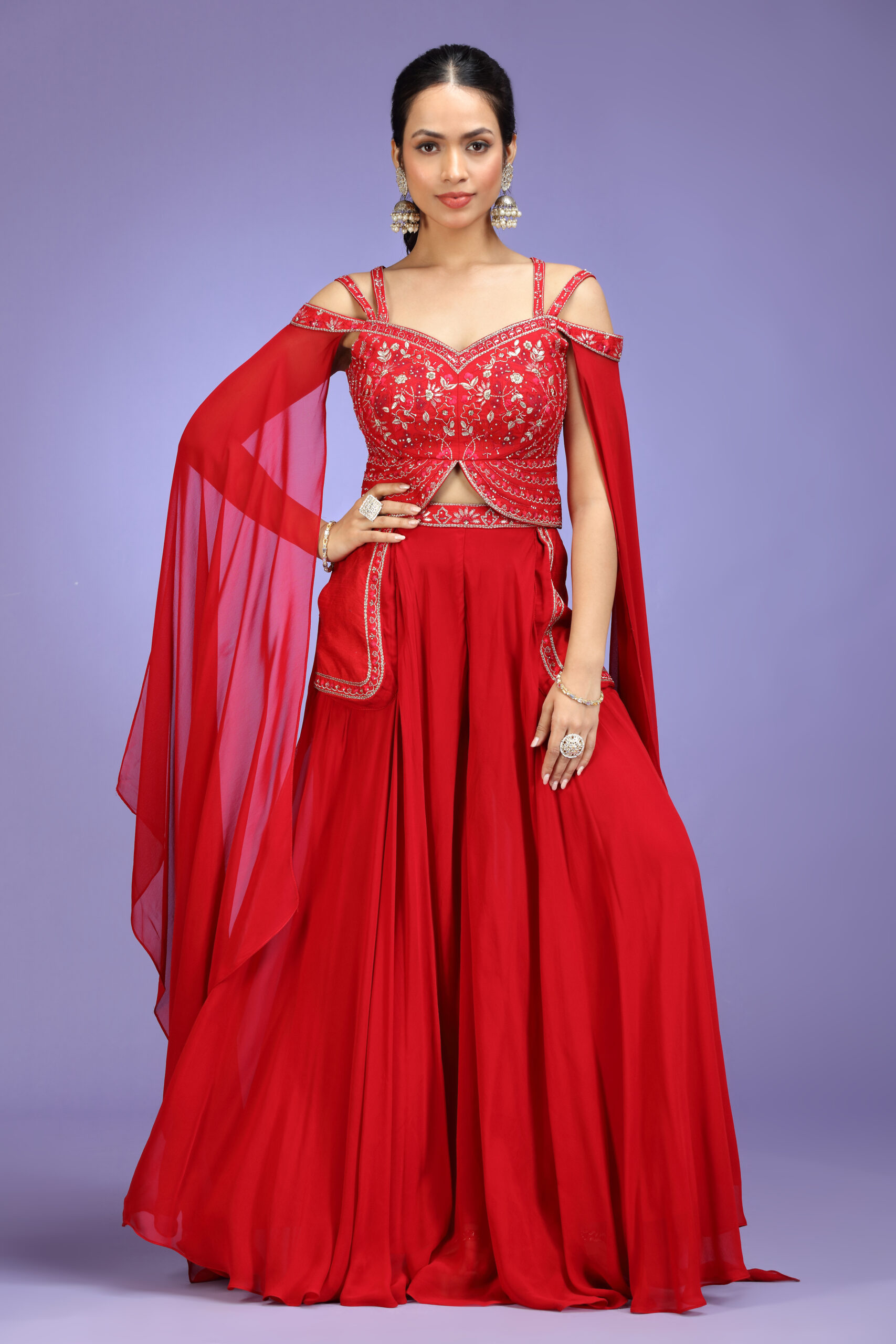 Golden Muslin red georgette embroidered Indo-Western skirt set with cold-shoulder cape-sleeve blouse and embroidered pocket skirt