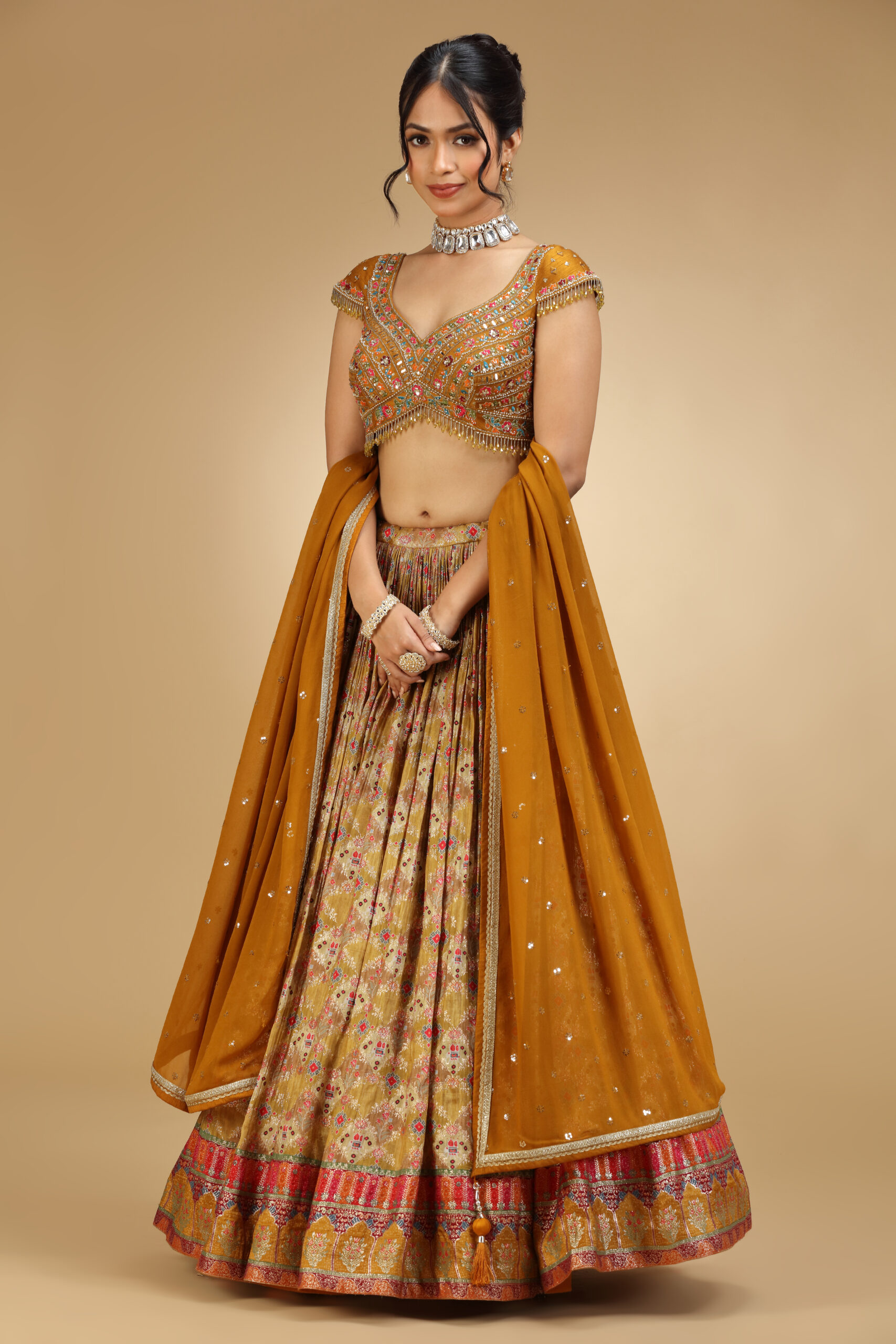 Golden Muslin mustard silk embroidered lehenga set with cap-sleeved embroidered blouse