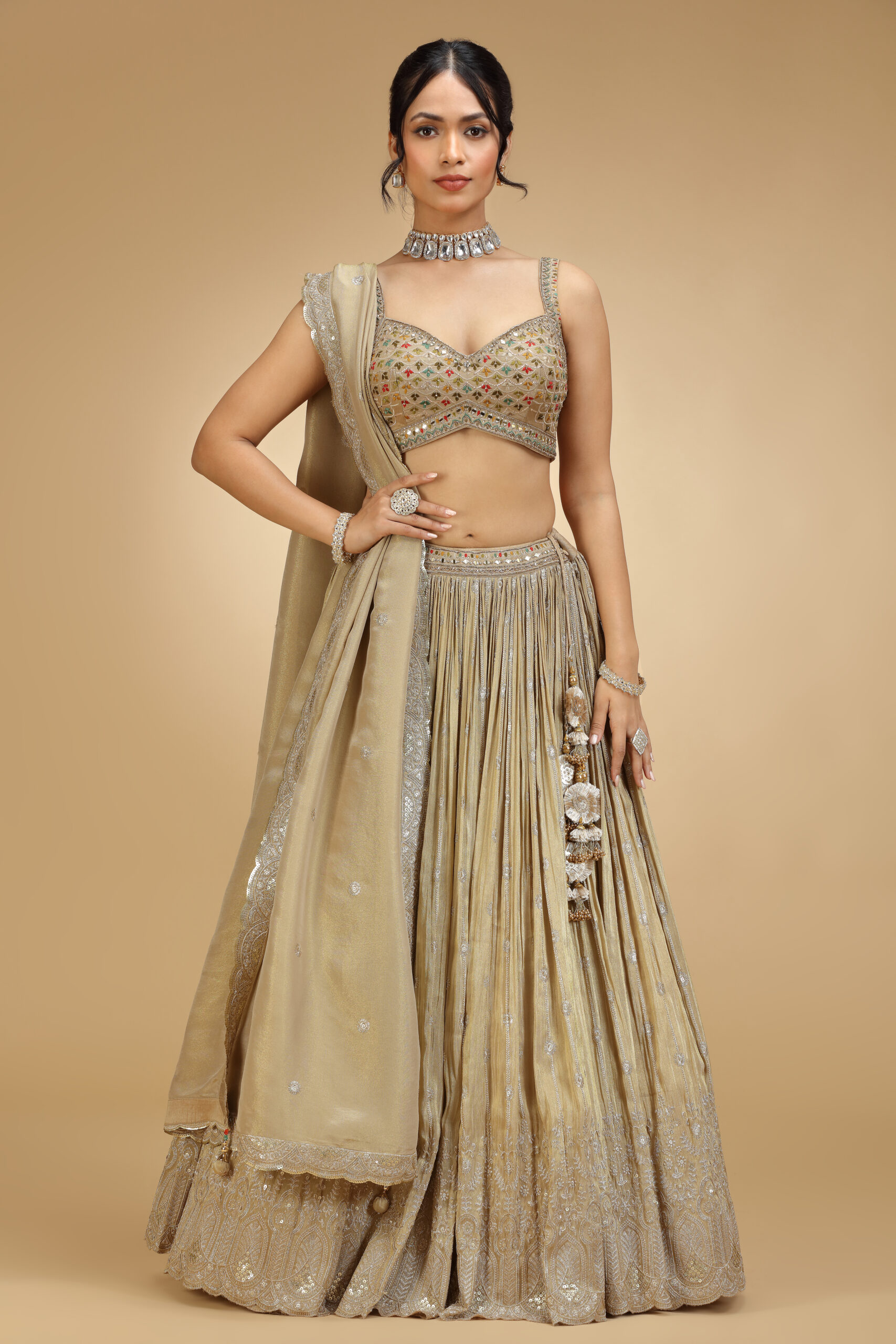 Golden Muslin gold tissue silver embroidered lehenga set with sleeveless embroidered blouse