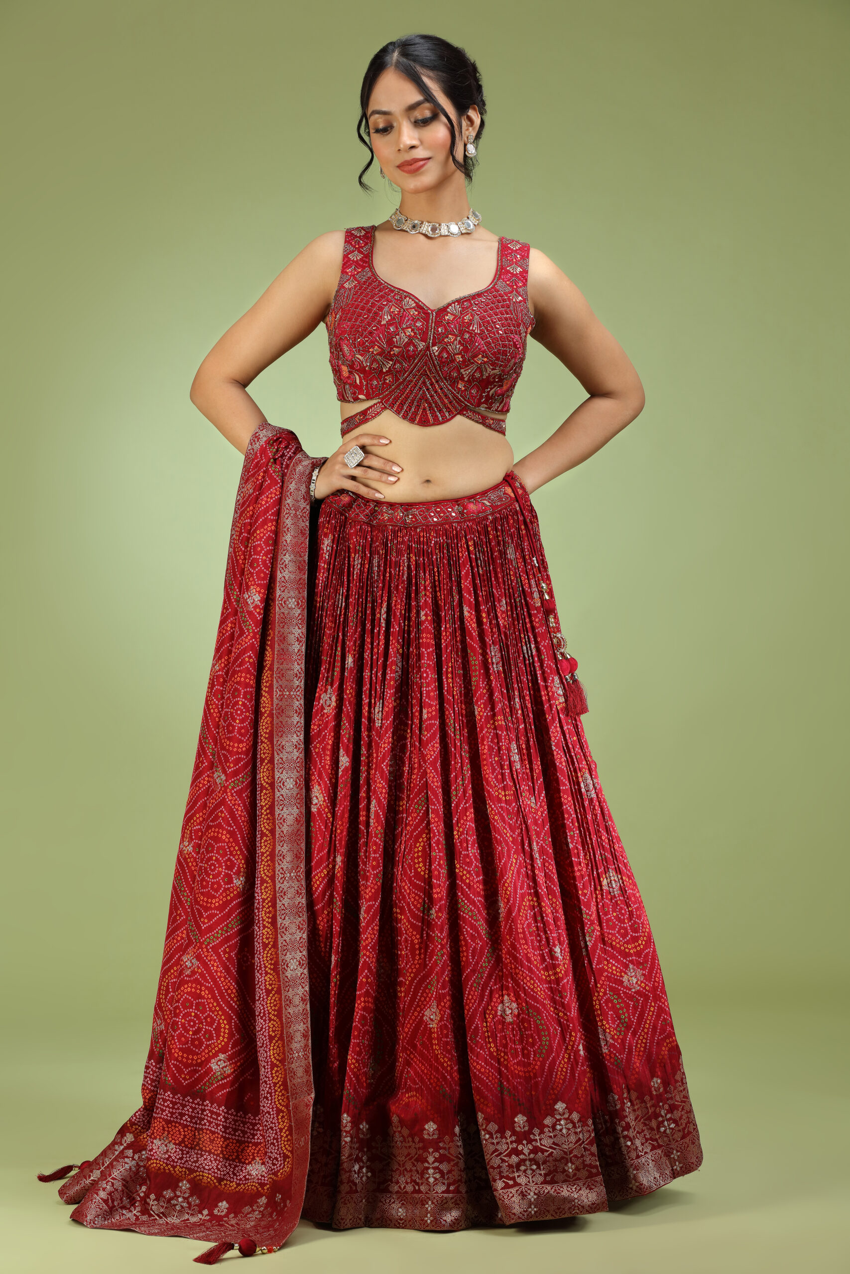 Golden Muslin red crepe bandhani print embroidered lehenga set with sleeveless embroidered blouse