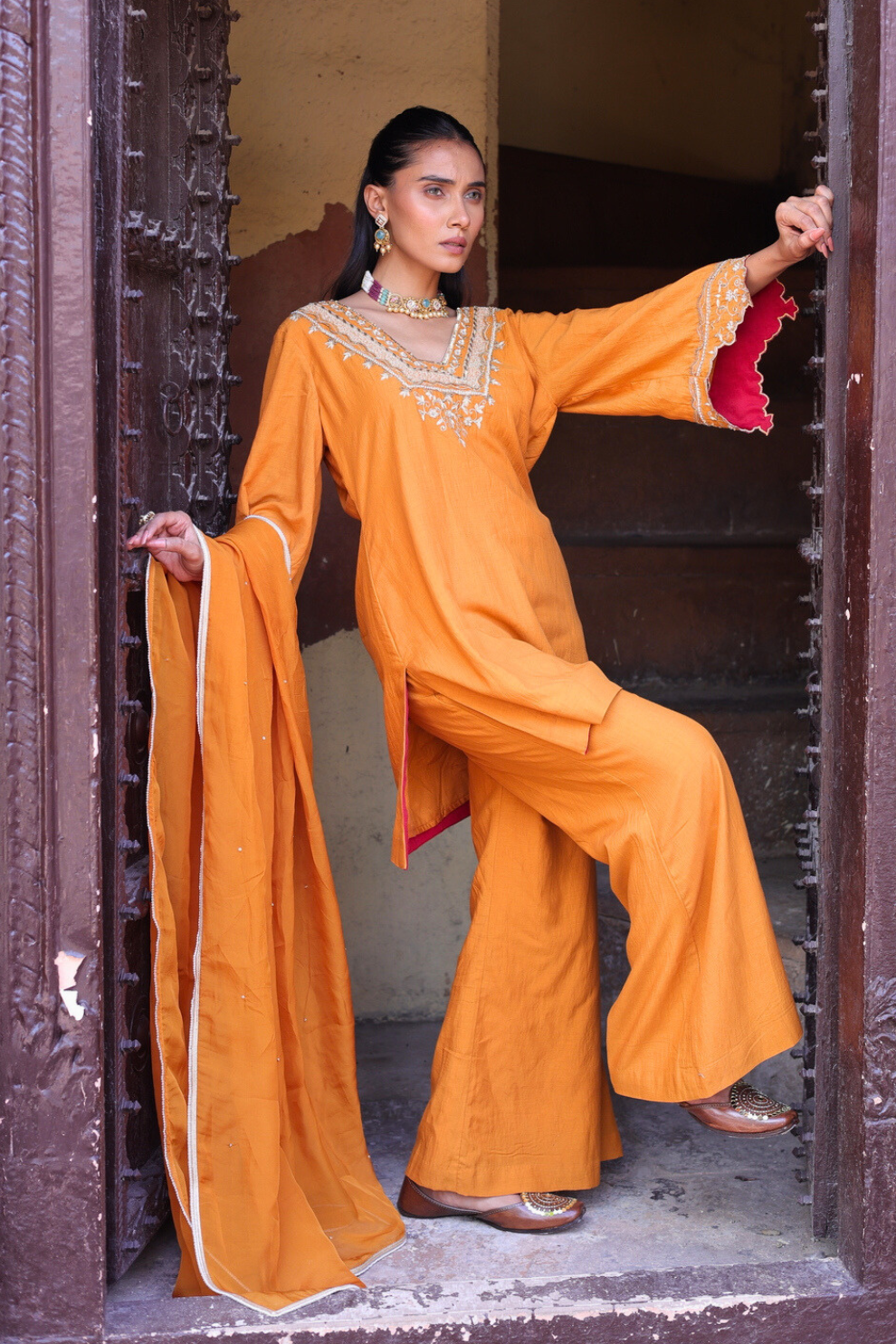 Tan orange mul chanderi three-piece kurta set by Golden Muslin featuring hand-embroidered motifs