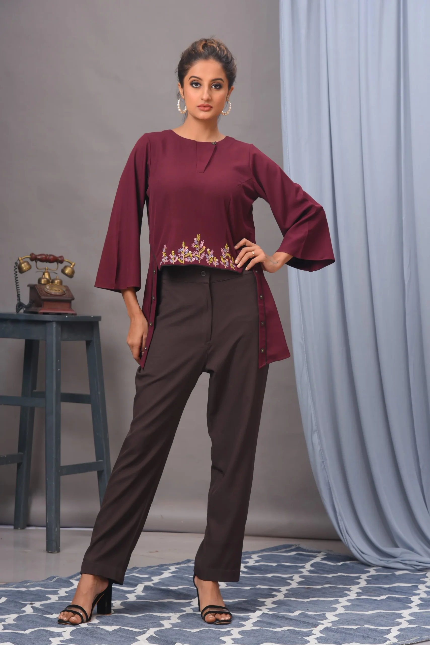 Wine crepe embellished top with matching pants set by Golden Muslin, crafted with refined detailing for a modern festive look.