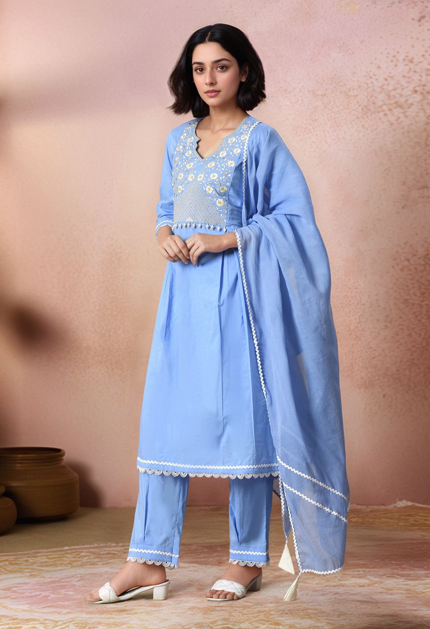 Golden Muslin light blue cotton straight kurta with embroidered yoke, pearl detailing, lace hem, paired with matching lace-finish pants and a soft organza dupatta.