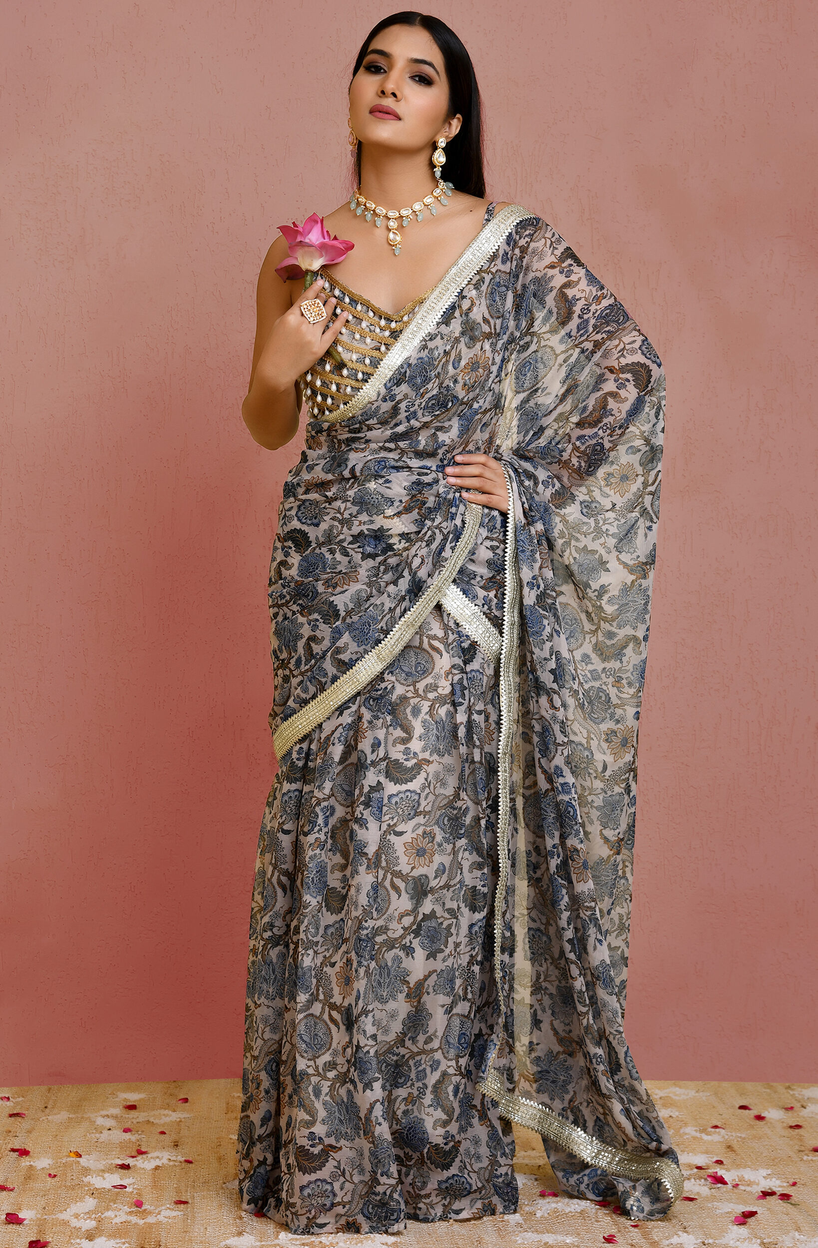 Beige and blue floral print pre-draped georgette saree with lace detailing and pearl-embellished blouse from Golden Muslin by Priyanka Rathore.