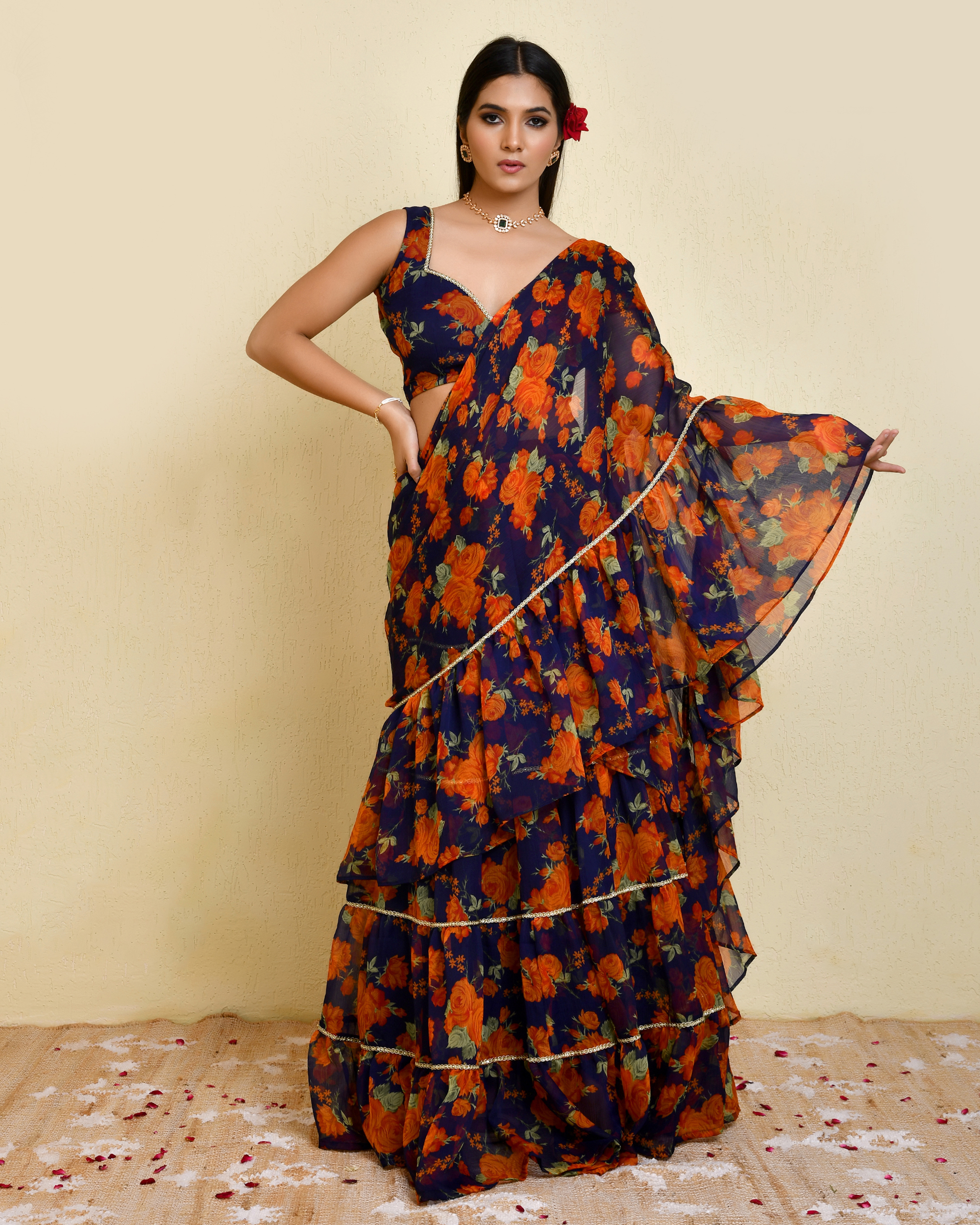 Dark blue and orange pre-draped floral printed chiffon saree with lace detailing and sleeveless padded blouse in Golden Muslin by Priyanka Rathore
