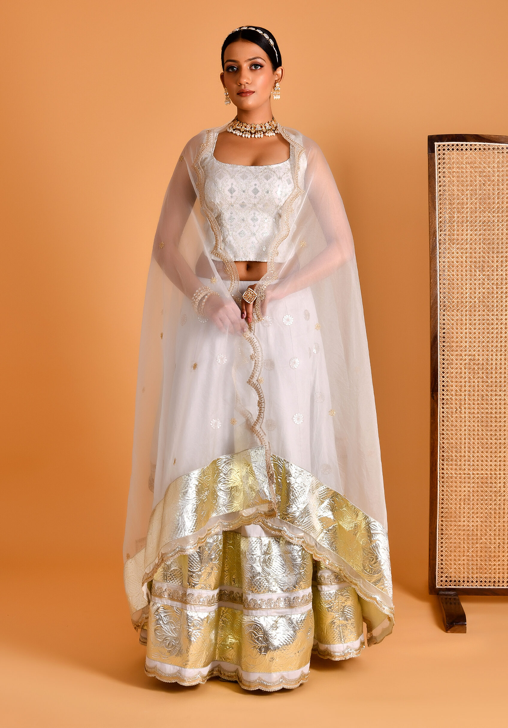 Ivory and gold gota work lehenga set with sequined backless blouse and dupatta from Golden Muslin by Priyanka Rathore