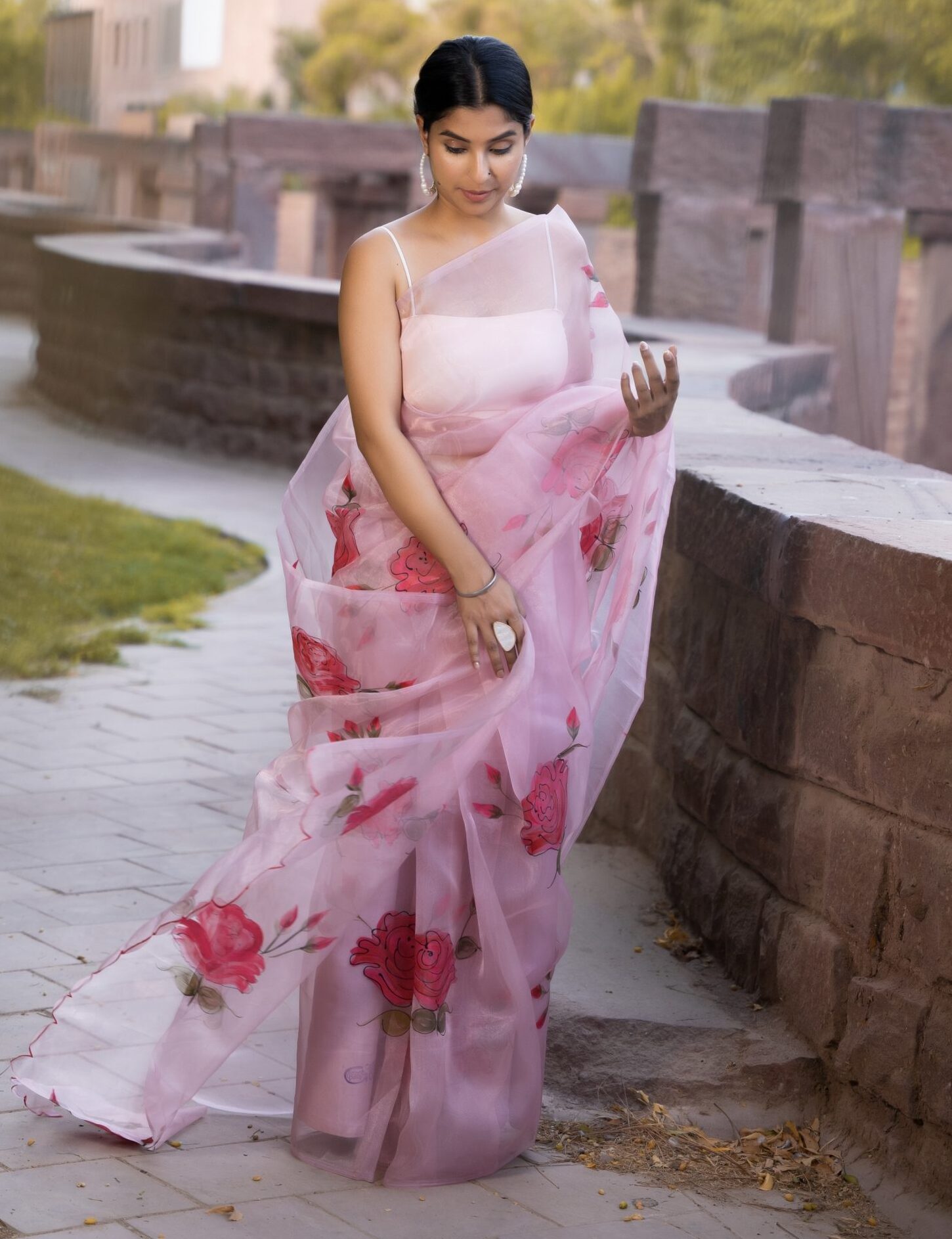 Pastel pink pure organza saree with hand-painted floral motifs, sheer lightweight drape and fluid movement in Golden Muslin by Priyanka Rathore