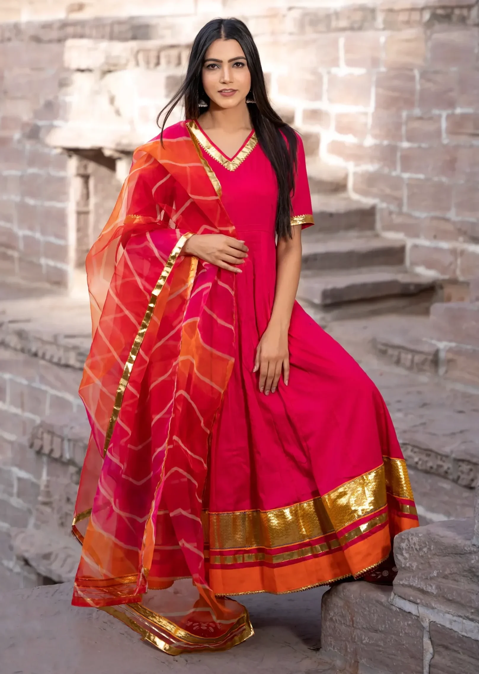 Two-piece floor-length Anarkali set with dramatic 36-kali flare and voluminous silhouette, designed for grand festive occasions with regal movement and elegance, Golden Muslin by Priyanka Rathore.