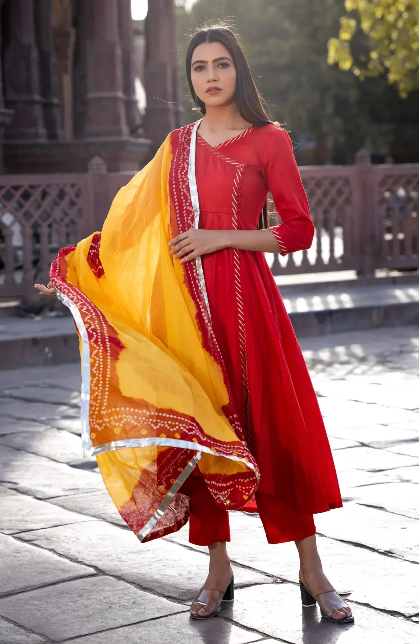 Deep red Angrakha suit set with wrap-style kurta and gota detailing, paired with straight-fit pants for festive elegance and comfort, Golden Muslin by Priyanka Rathore.