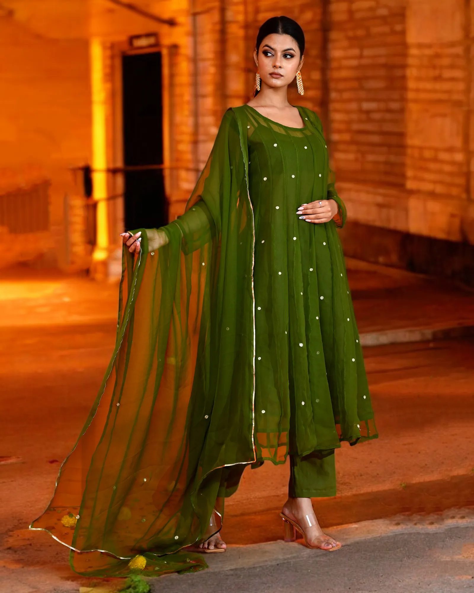 Olive green georgette Anarkali suit set by Golden Muslin by Priyanka Rathore featuring a flowing silhouette with delicate aari embroidery and refined festive detailing