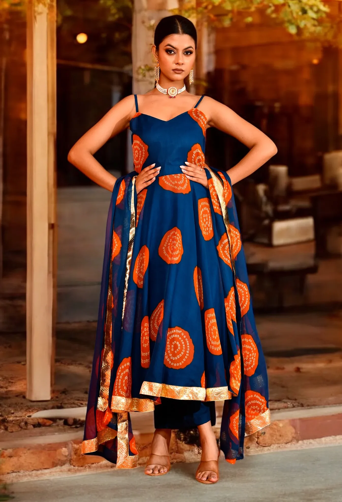 Teal blue printed chiffon Anarkali suit set with artistic prints and delicate gota work detailing, offering fluid elegance and festive shimmer, Golden Muslin by Priyanka Rathore.