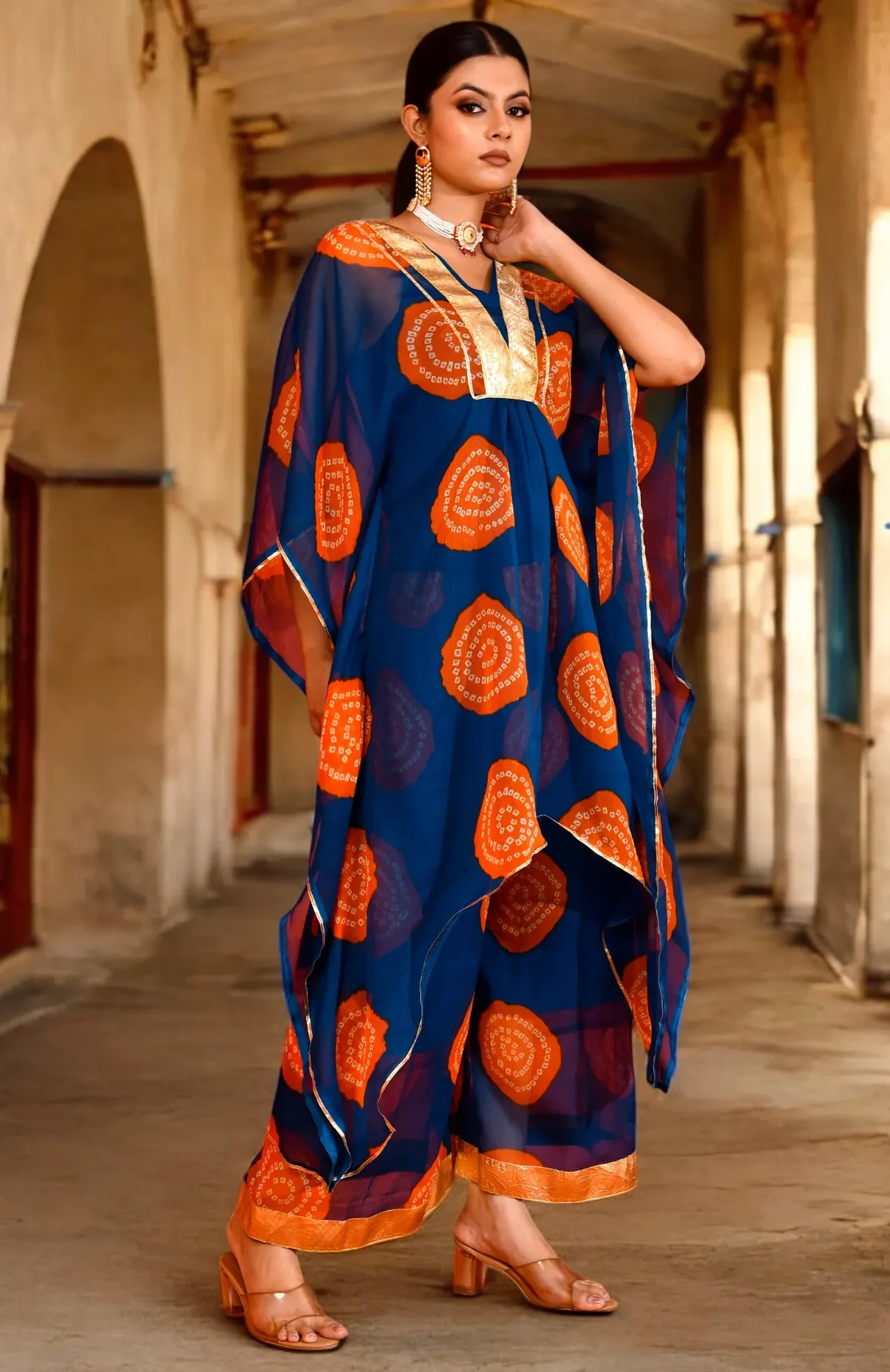 A stylish teal blue printed chiffon kaftan set featuring delicate gota work accents from Golden Muslin by Priyanka Rathore, perfect for contemporary festive styling.