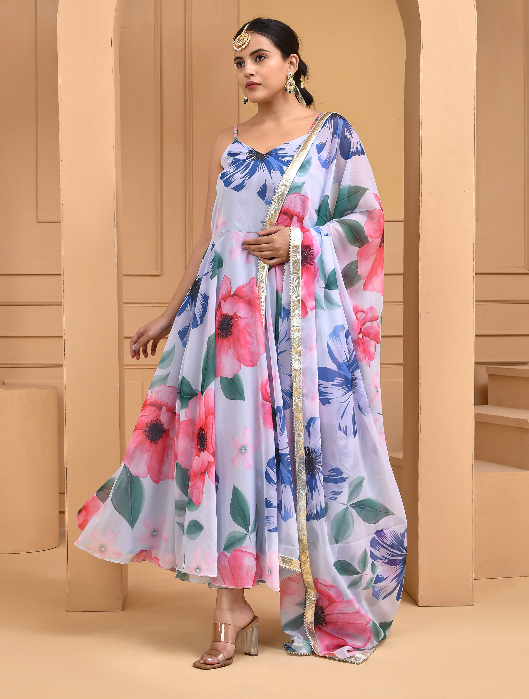 Smoke white georgette floral print flared Anarkali set with noodle straps, cotton pants and matching floral dupatta finished with subtle gota detailing in Golden Muslin by Priyanka Rathore