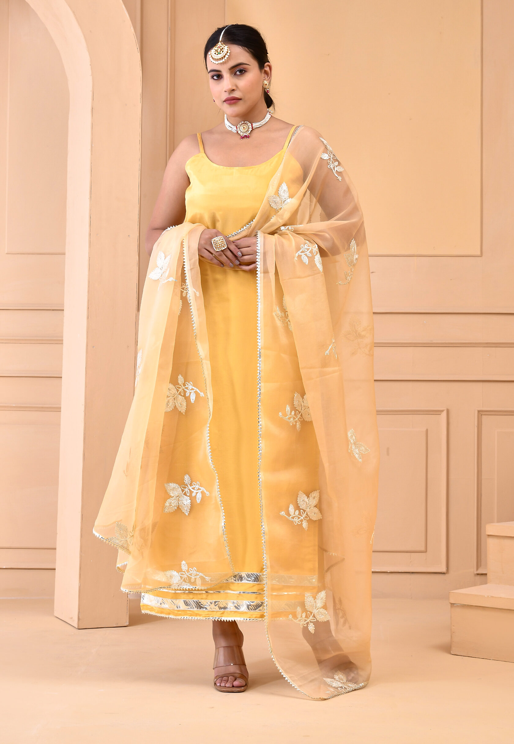 Yellow Uppada silk straight kurta set with scoop neckline, noodle straps, gota lace detailing and embroidered organza dupatta in Golden Muslin by Priyanka Rathore