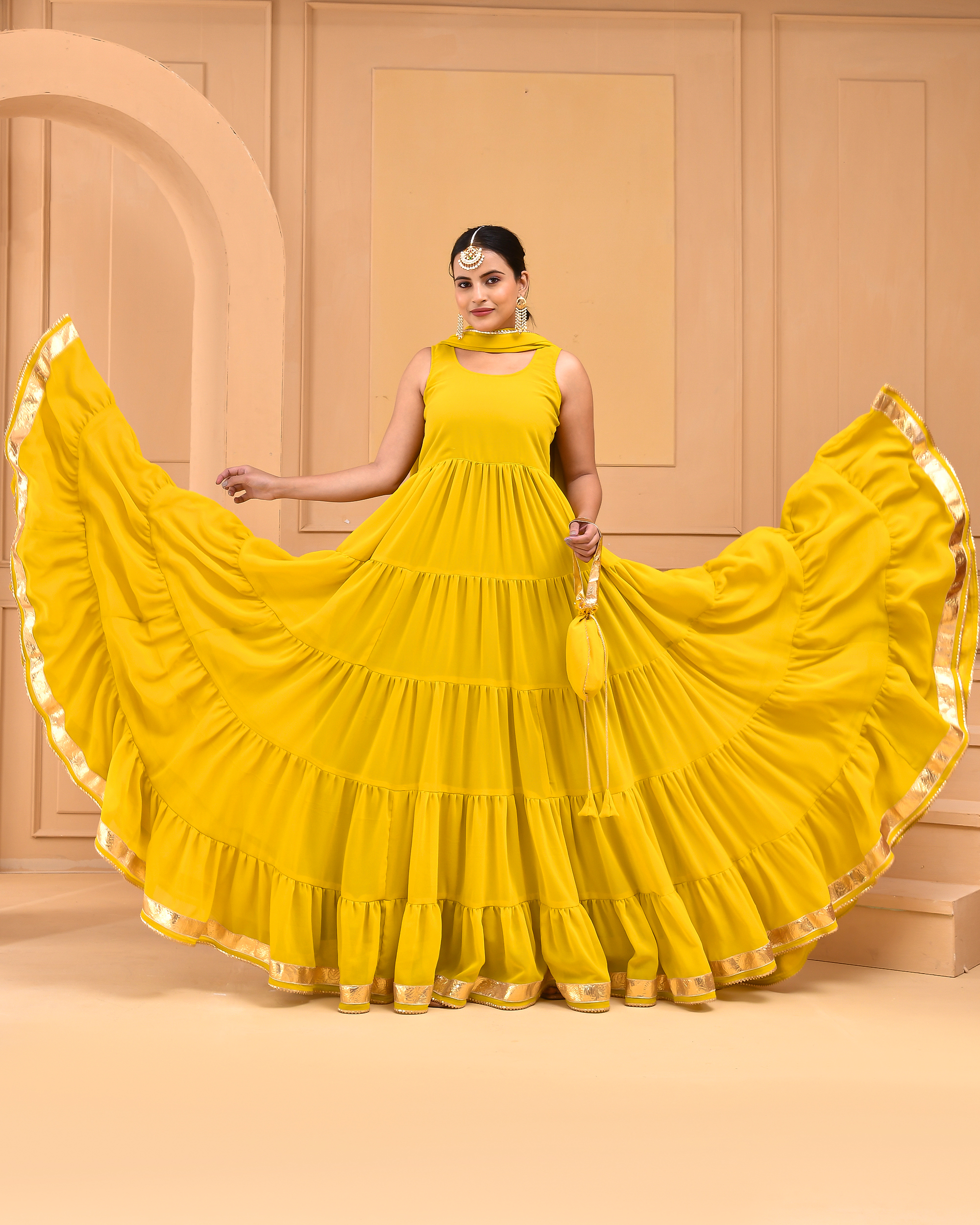 Yellow georgette tiered anarkali set with gota detailing, dupatta and potli from Golden Muslin by Priyanka Rathore