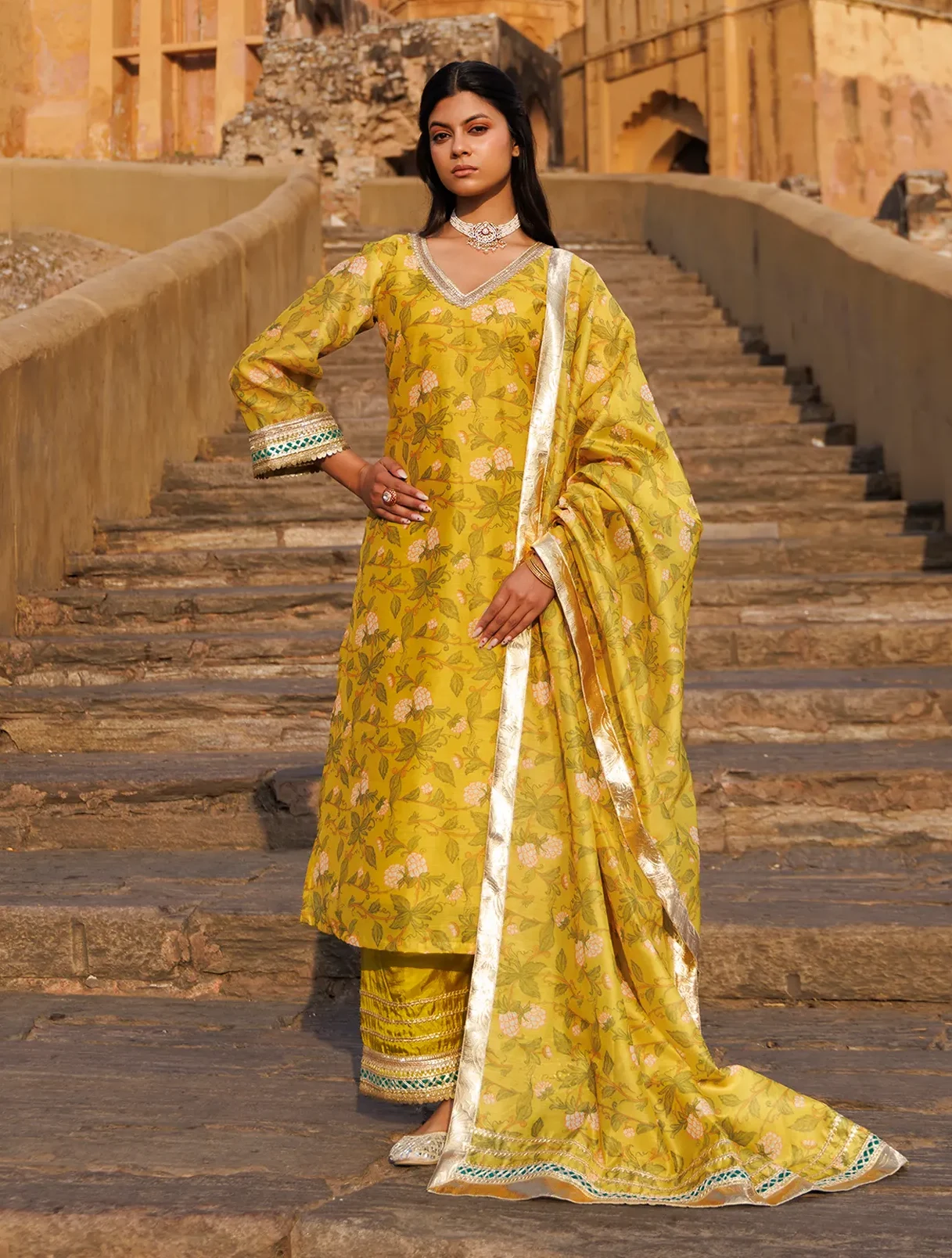 Yellow Chanderi kurta set with soft floral prints, gota accents and subtle sequin detailing from Golden Muslin by Priyanka Rathore