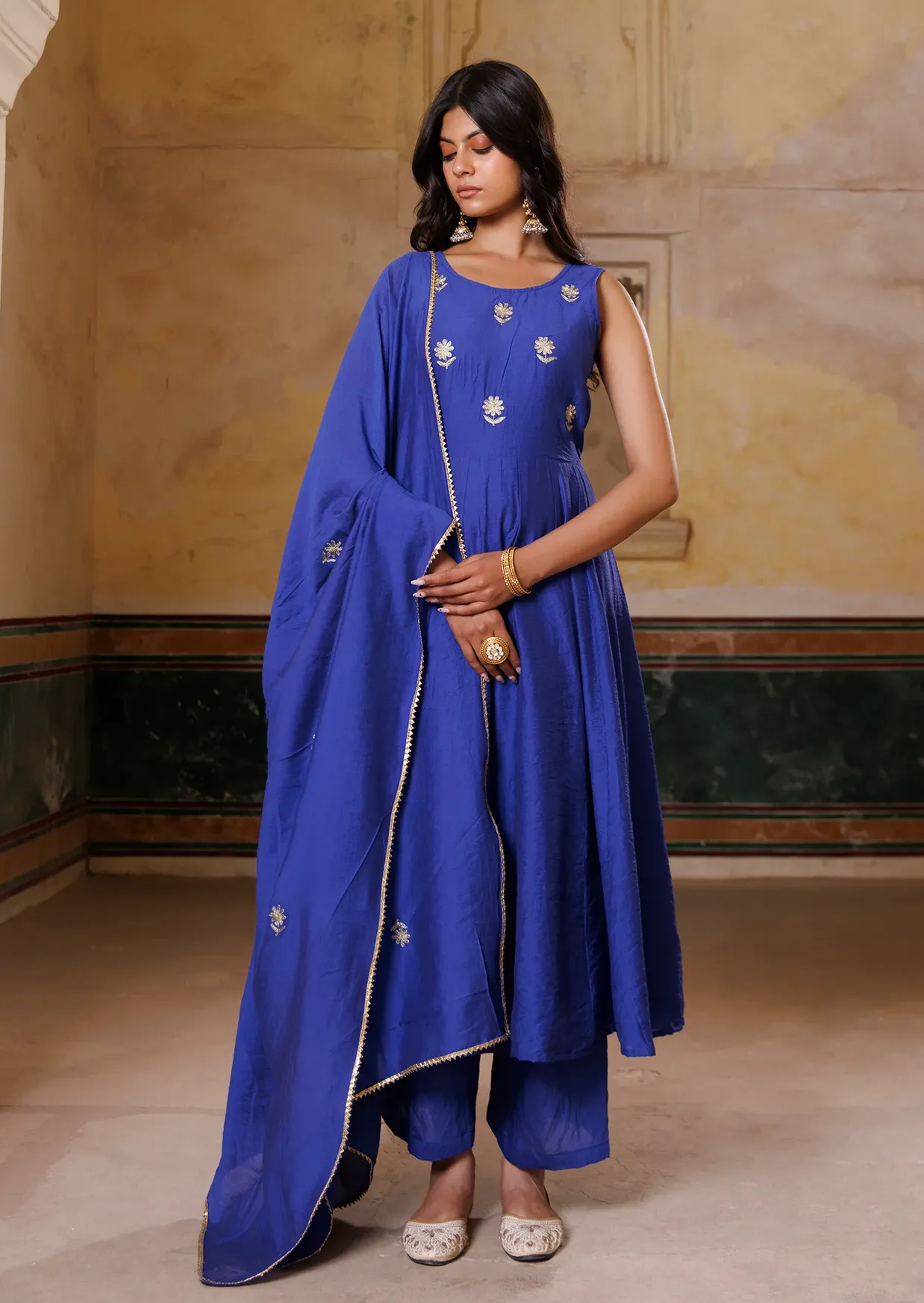 Blue Chanderi kurta set with delicate aari embroidered floral motifs and fluid drape from Golden Muslin by Priyanka Rathore