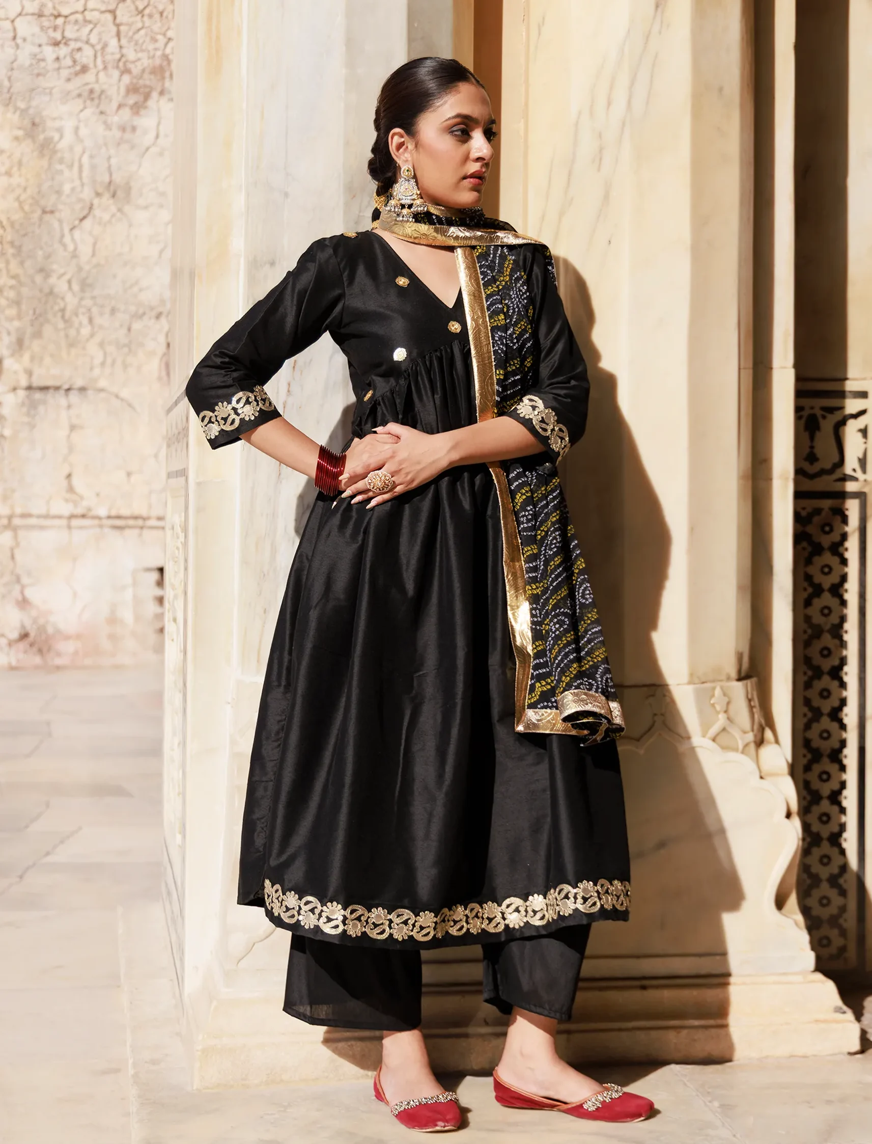 Black Dupion silk Anarkali set with V-neck, sequin detailing and gota patti appliqué from Golden Muslin by Priyanka Rathore